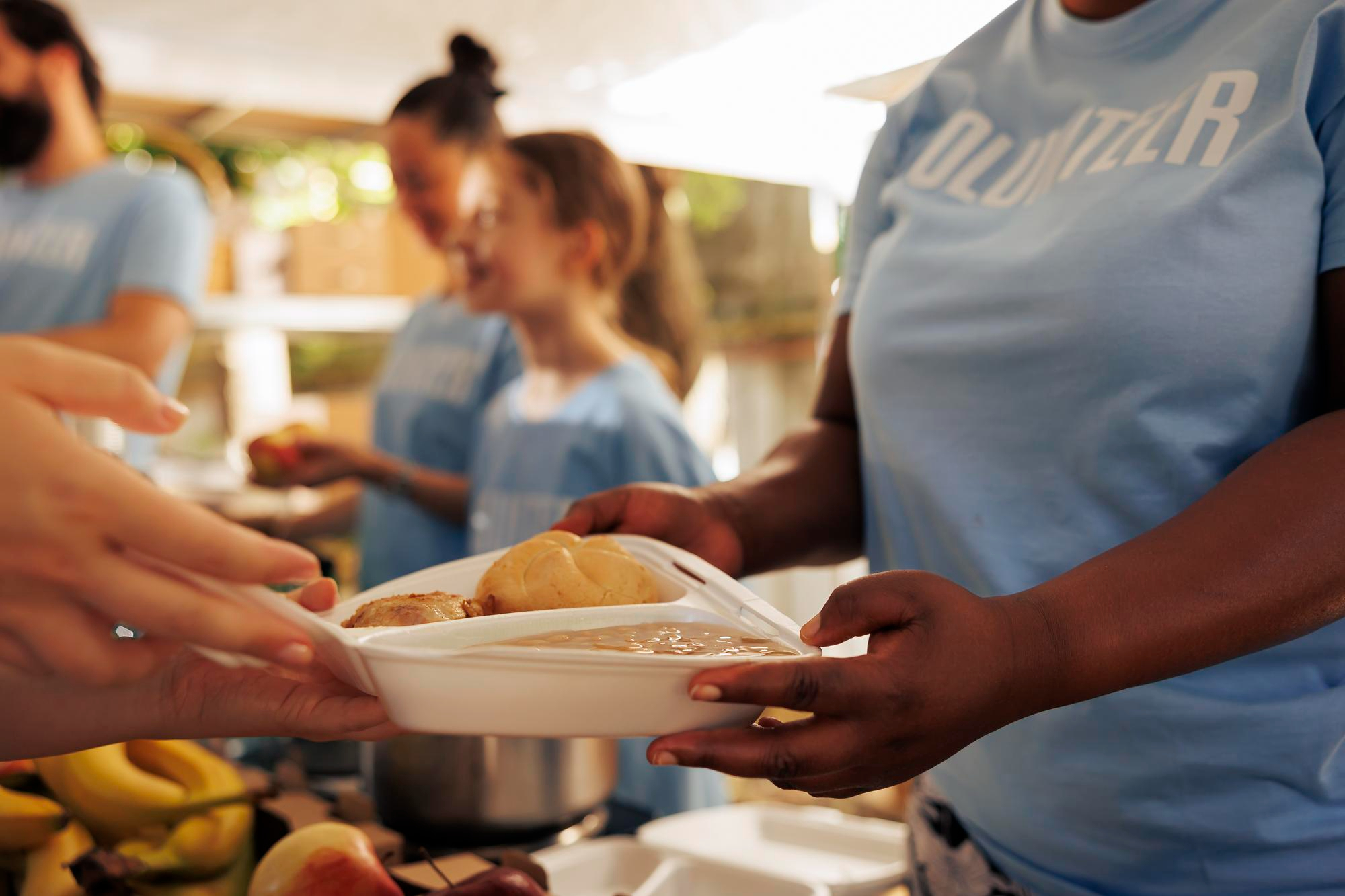 Volunteers working at a homeless shelter | Source: Freepik