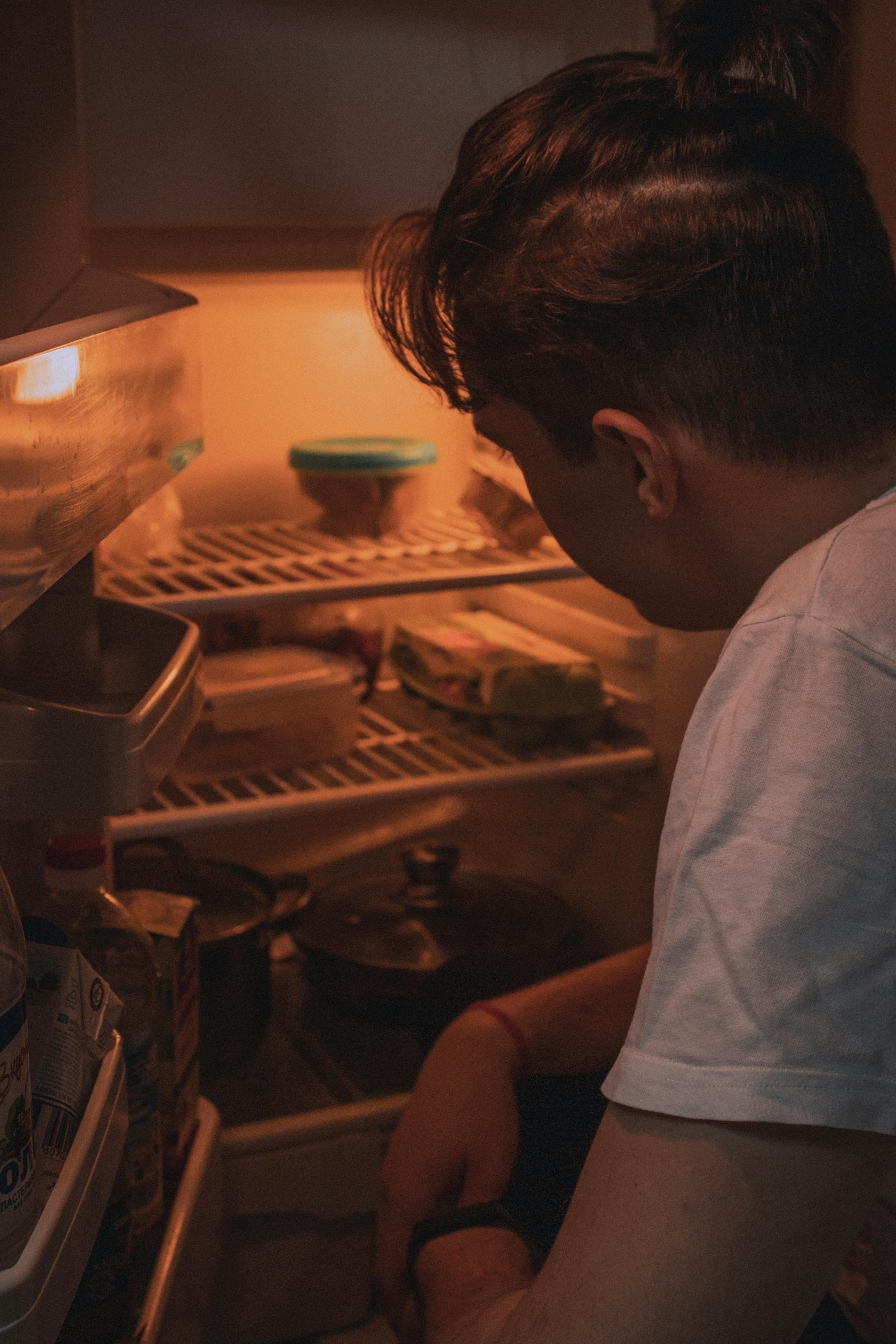 A man rummaging for something in the fridge | Source: Pexels