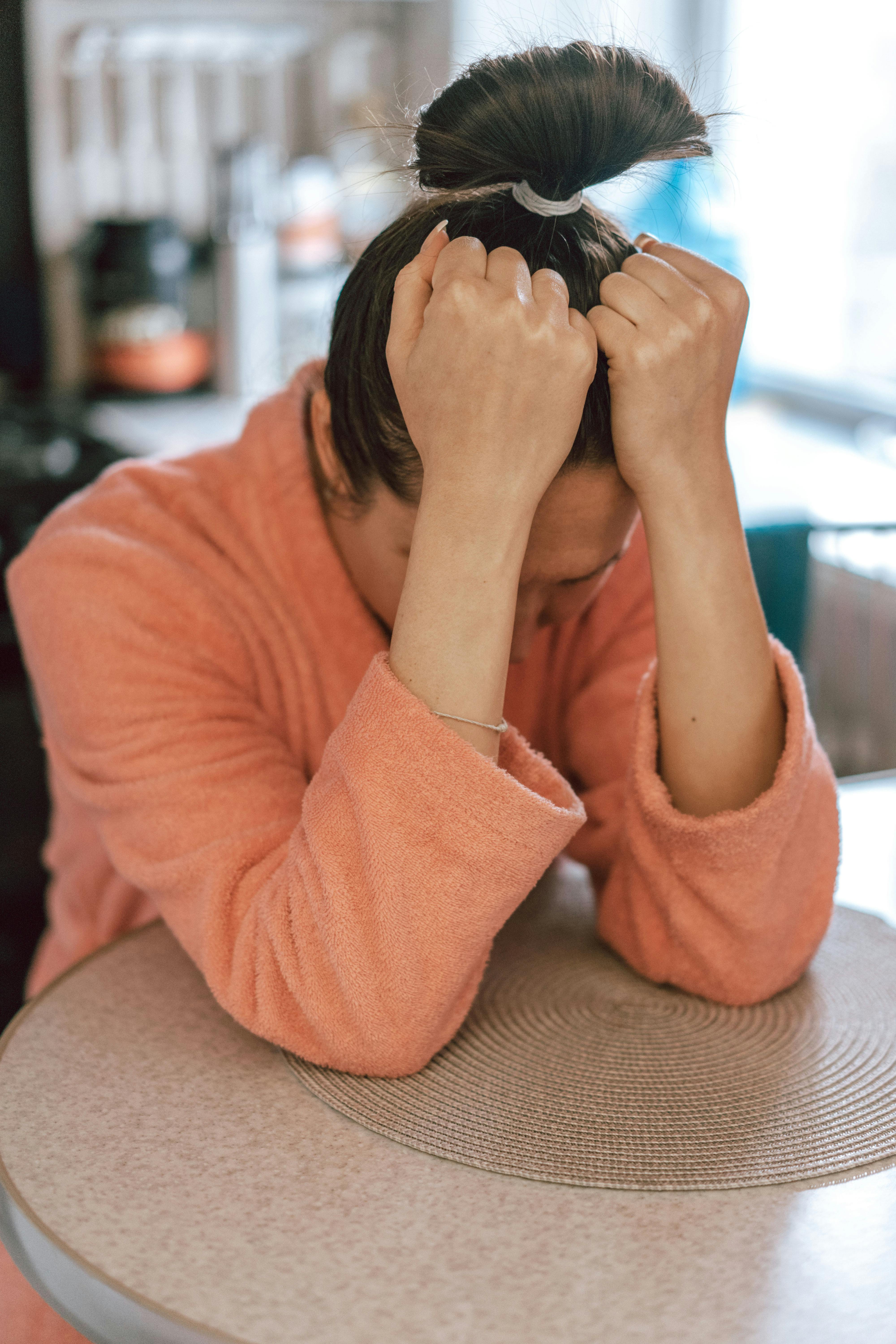 A sad woman in a robe | Source: Pexels