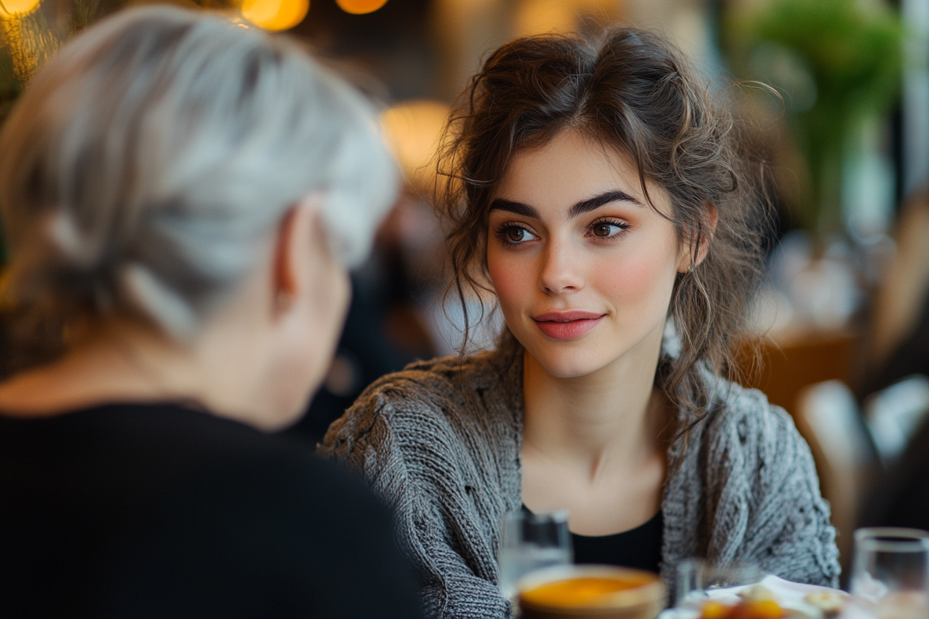 A woman having a conversation with her mother-in-law over lunch | Source: Midjourney