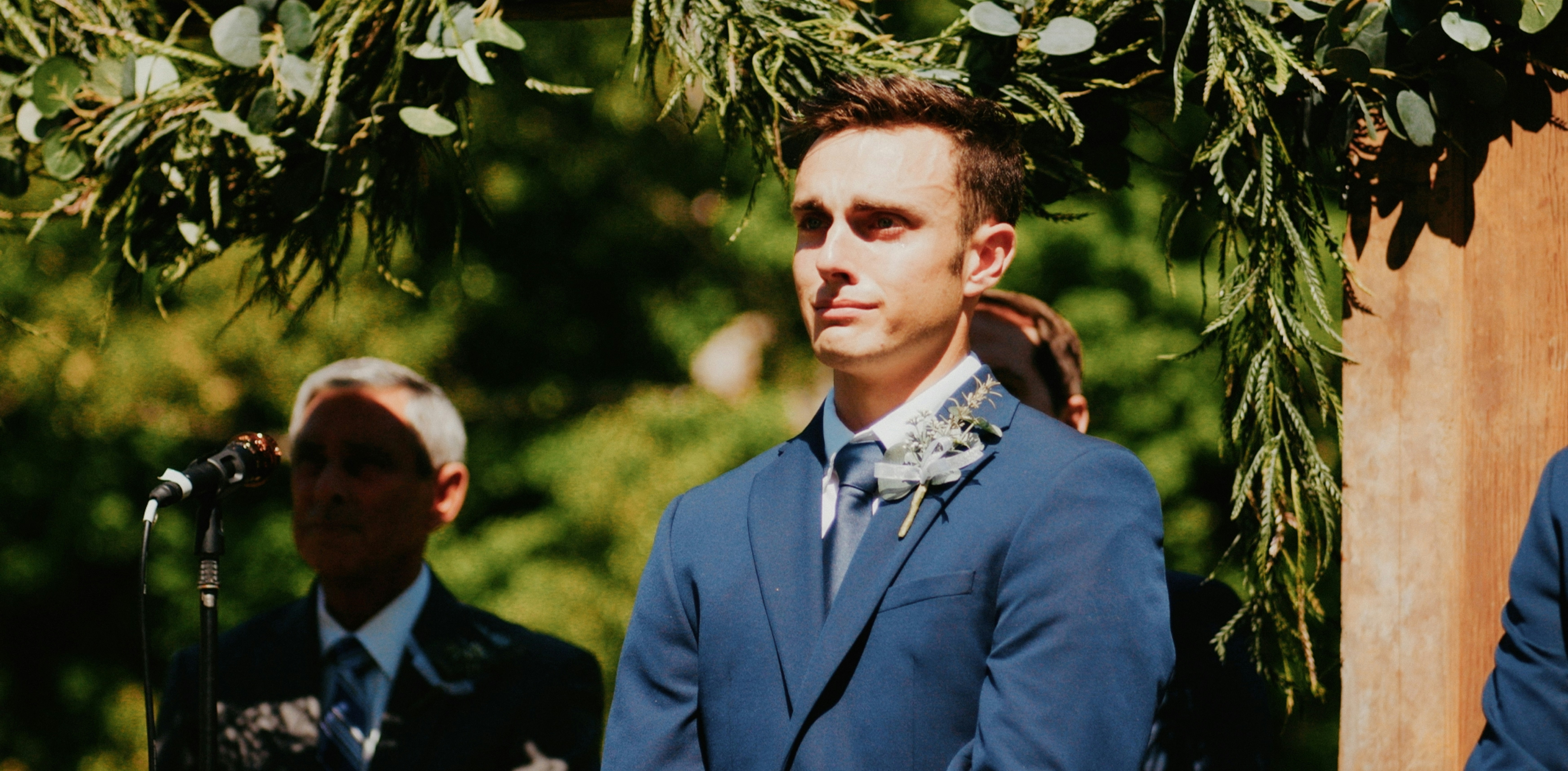 Groom with a senior man in the background | Source: Unsplash
