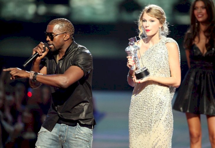 Kanye West jumps onstage after Taylor Swift won the "Best Female Video" award during the 2009 MTV Video Music Awards at Radio City Music Hall on September 13, 2009 in New York City. | Photo by Christopher Polk/Getty Images