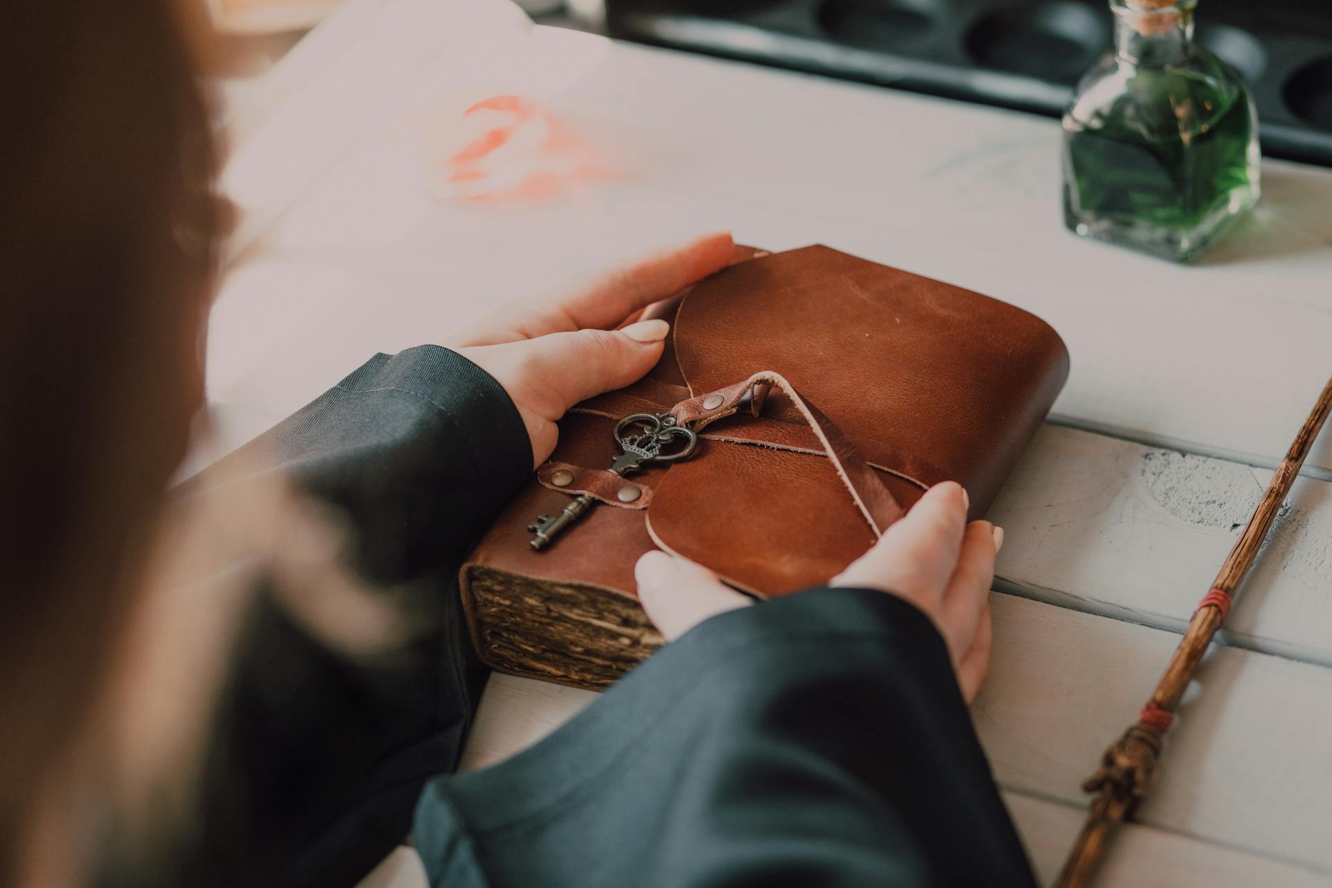 A woman holding a brown leather journal | Source: Pexels
