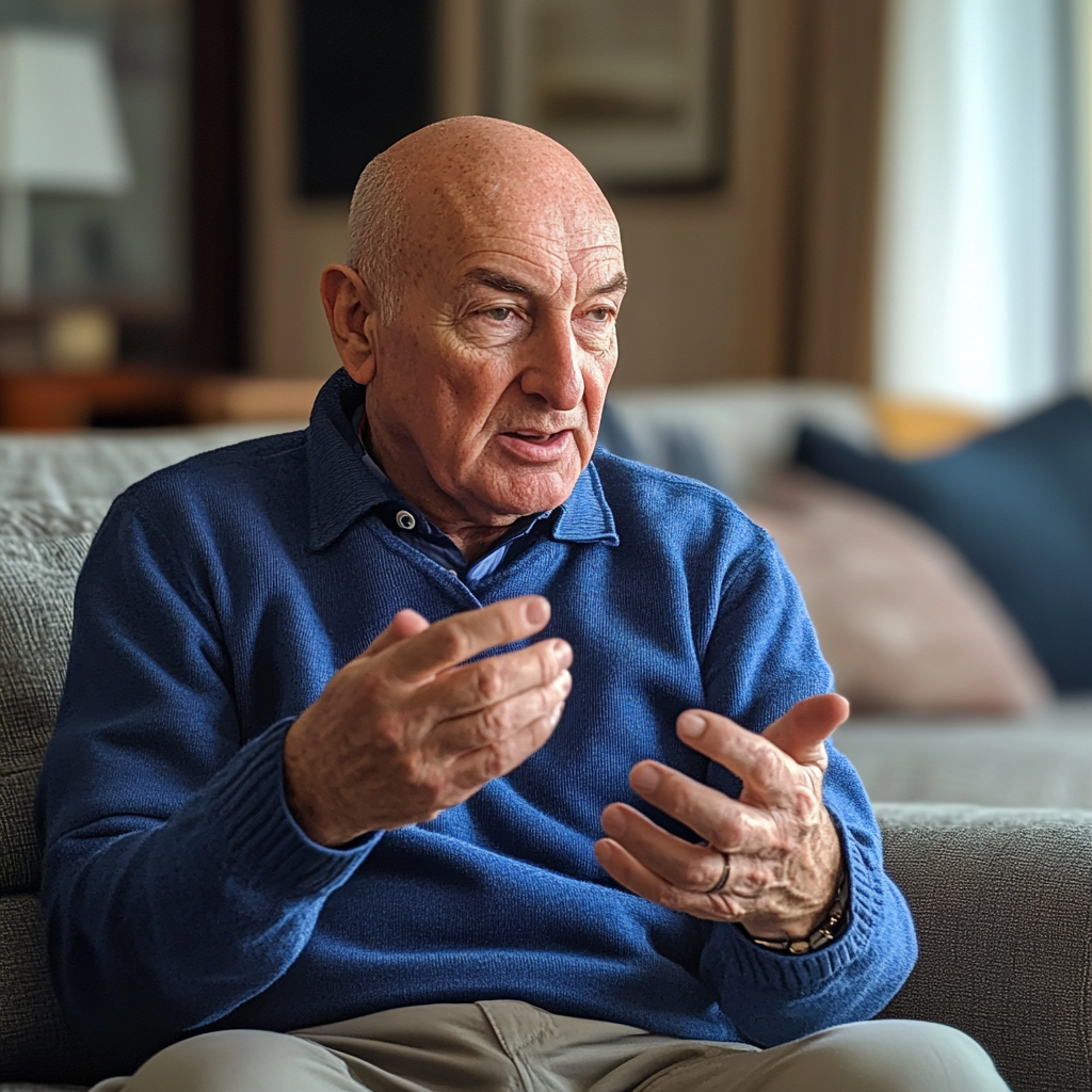 An older man sitting on a couch and talking | Source: Midjourney