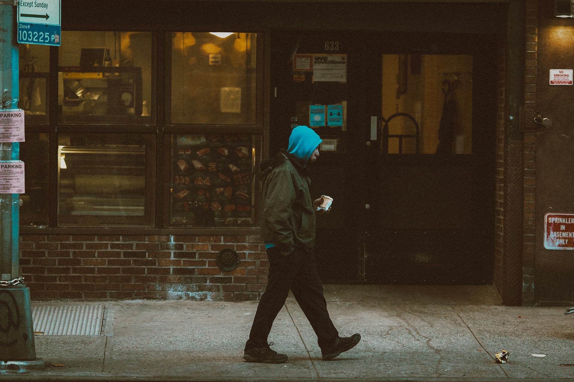 A man walking on the street with a coffee cup in hand | Source: Unsplash