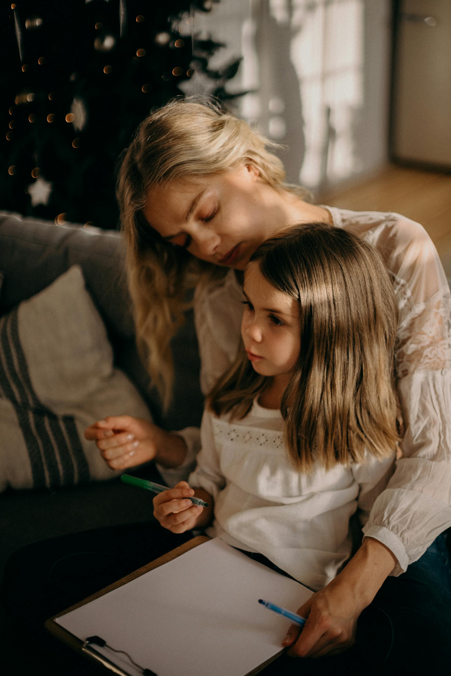 A mother sitting with her little daughter | Source: Pexels