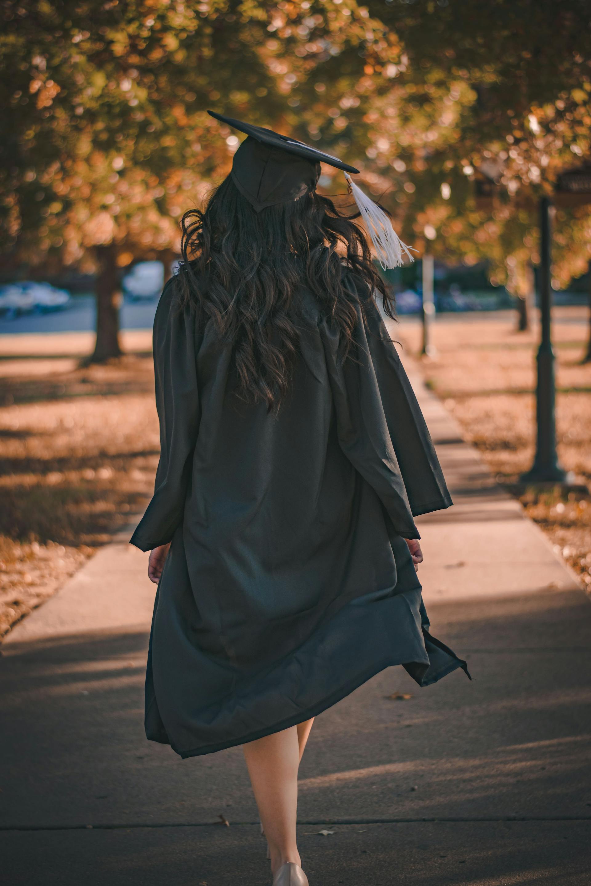 A woman dressed in a cap and gown for graduation | Source: Pexels