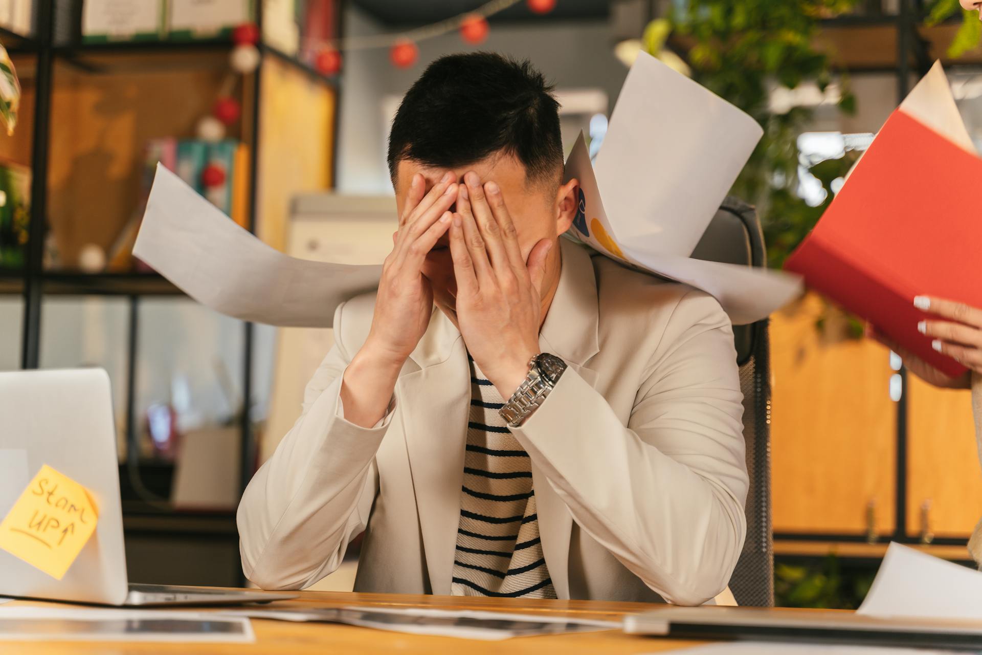 A tired man sitting in his office | Source: Pexels