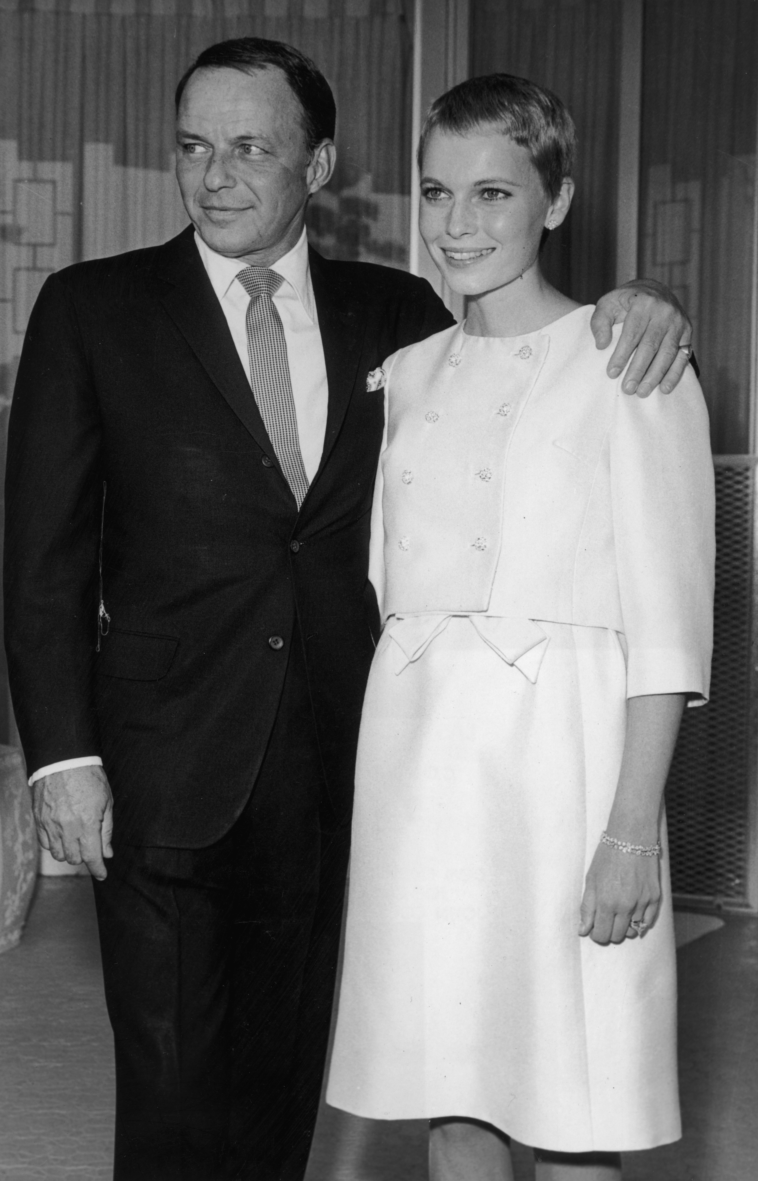 Frank Sinatra (1915 - 1998) stands with his arm around his third wife, actor Mia Farrow, during their private wedding in Las Vegas, Nevada, on July 19, 1966. | Source: Getty Images