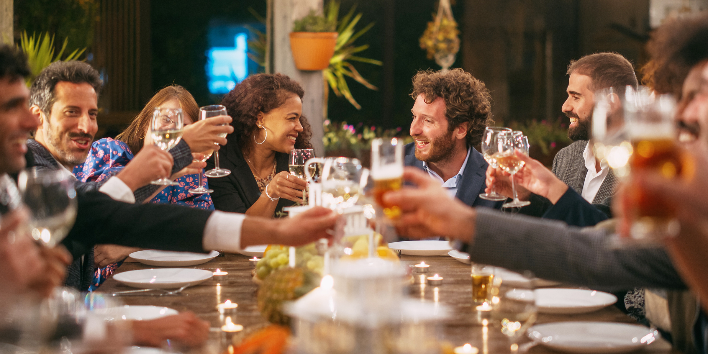 Guests toasting at a dinner party | Source: Shutterstock