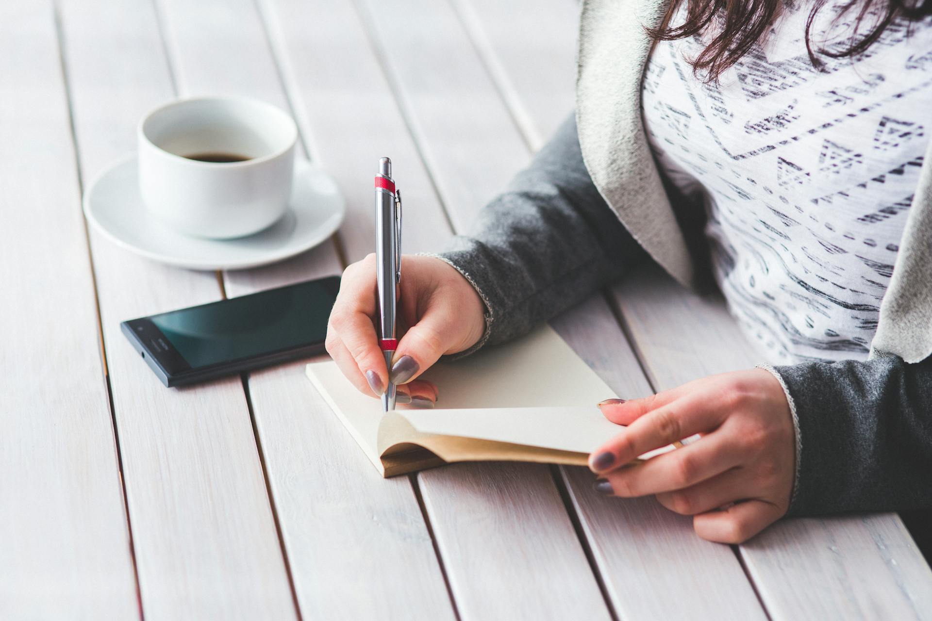 A woman writing in a notebook | Source: Pexels
