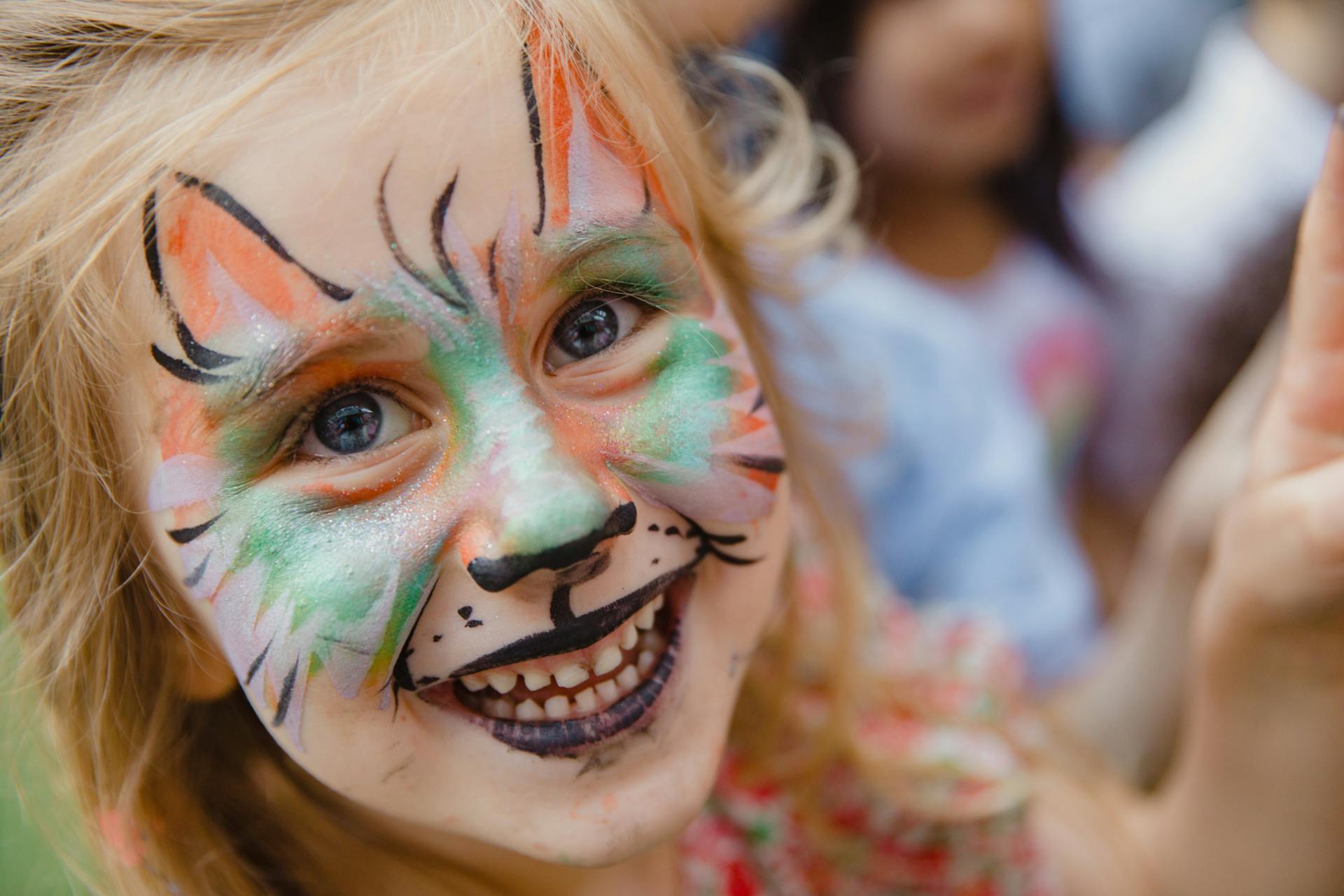 A delighted little girl with face paint | Source: Pexels