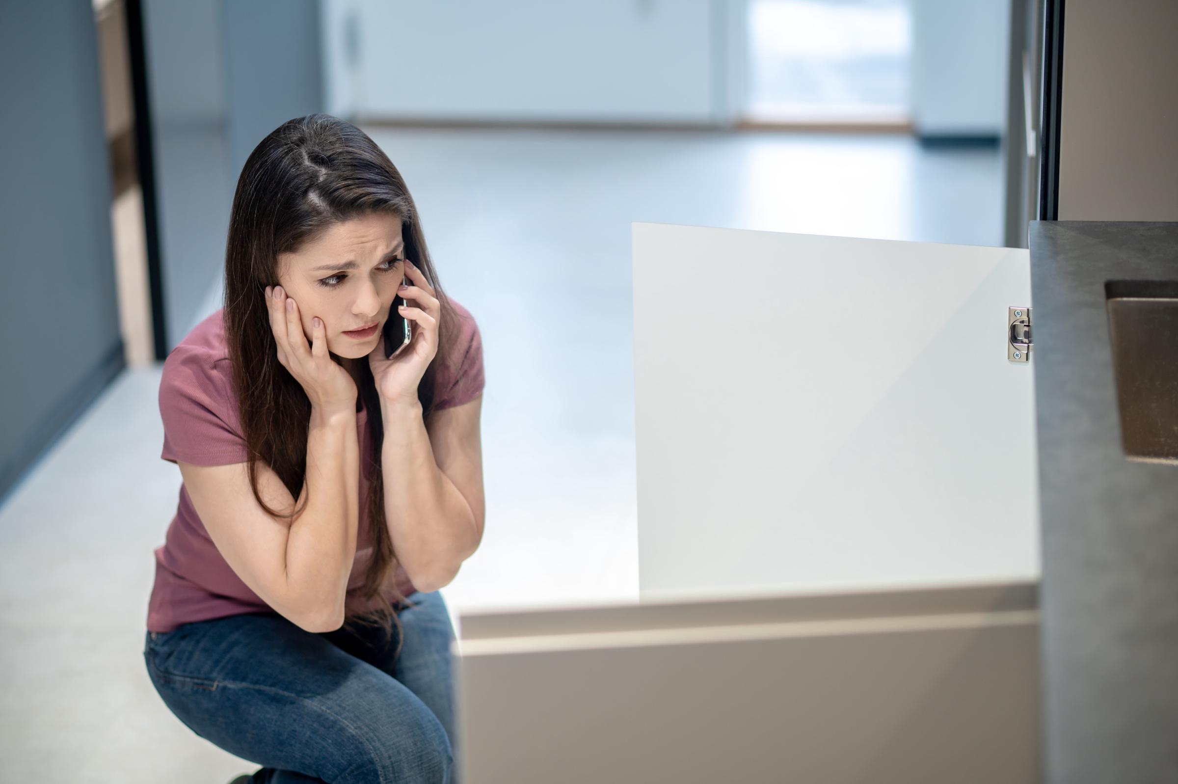 A stressed woman on a call | Source: Freepik