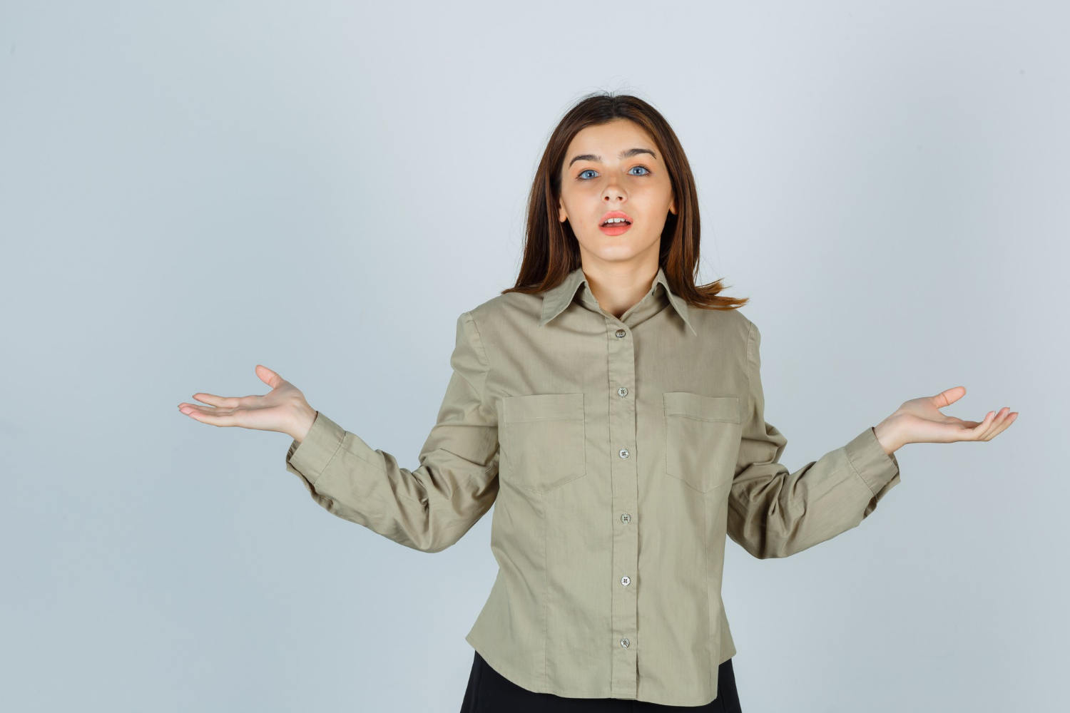 A frustrated woman shrugging | Source: Freepik