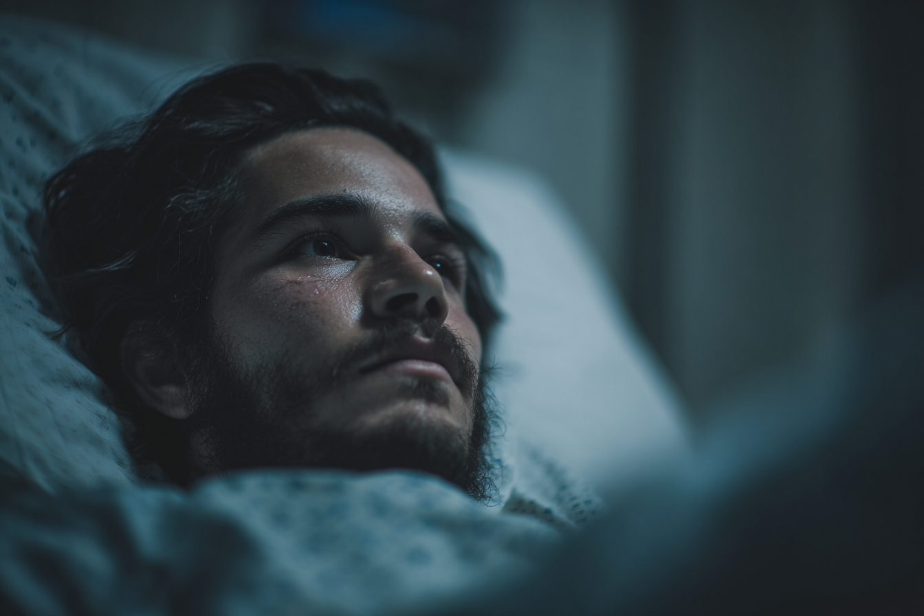 A man in a hospital bed staring plaintively at someone | Source: Midjourney