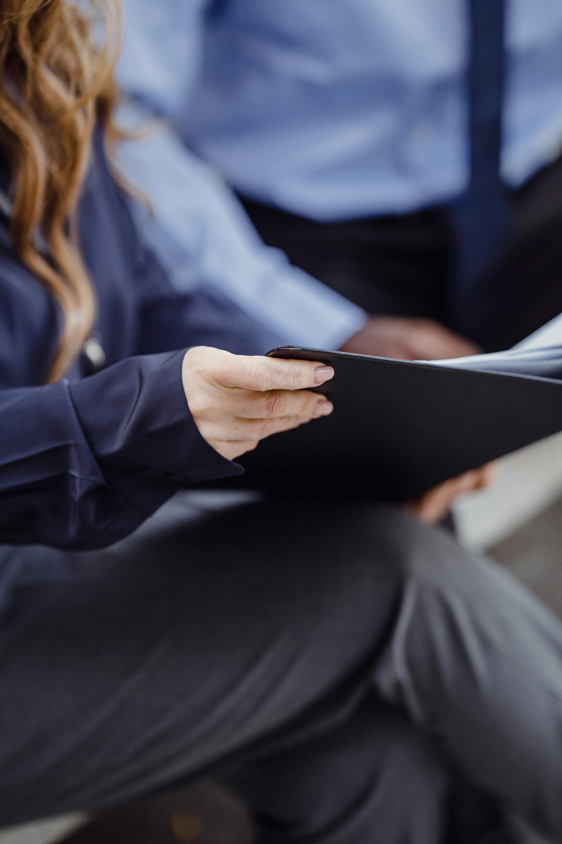 A woman holding a folder | Source: Pexels