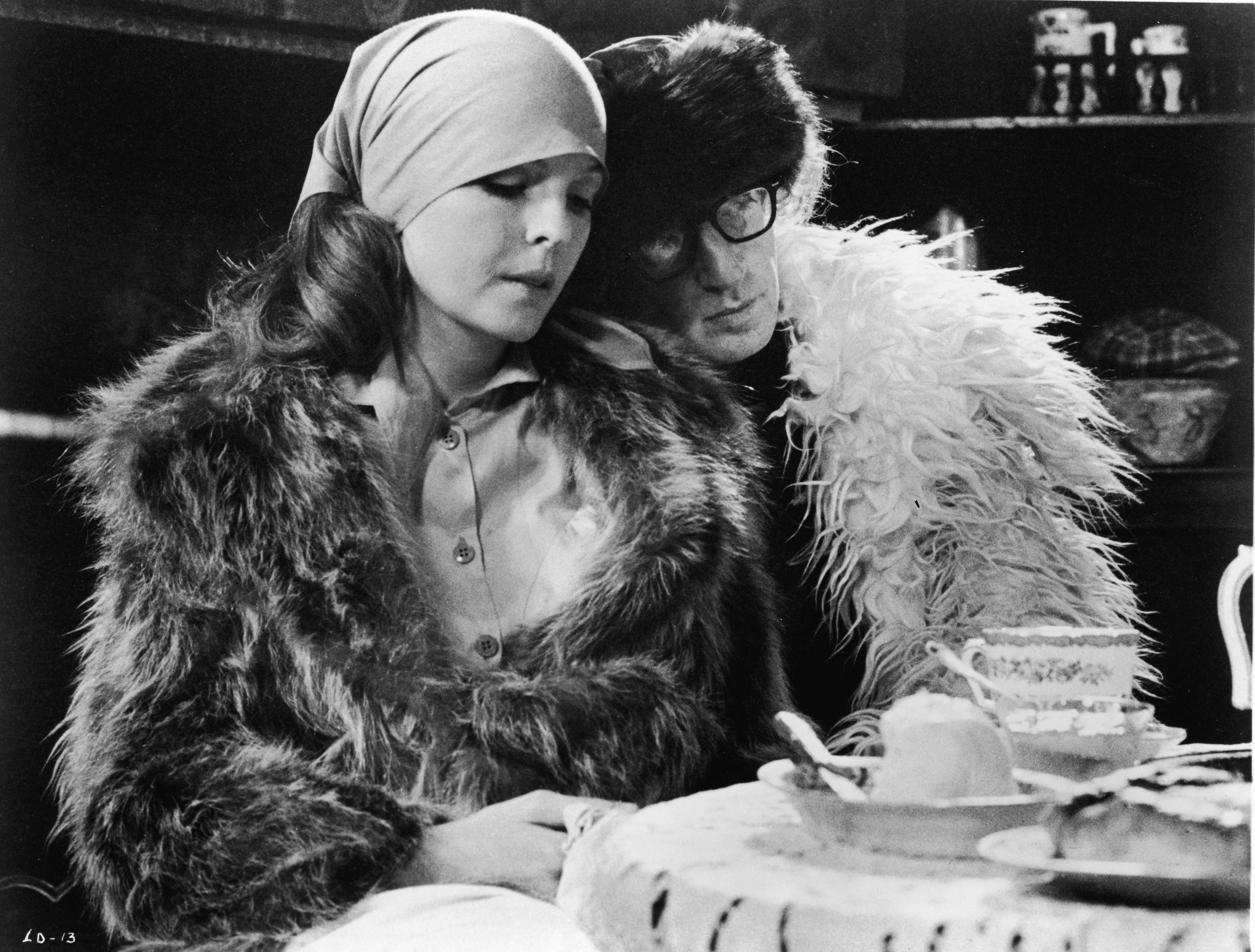 Woody Allen leans his head on the shoulder of Diane Keaton in a scene from "Love and Death," circa 1975. | Source: Getty Images