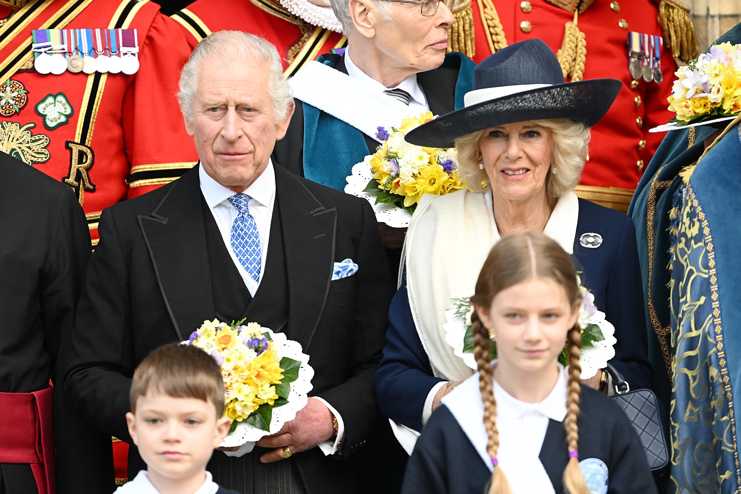 King Charles III and Queen Camilla pose with religious representatives holding nosegay bouquets after the Royal Maundy service at York Minster on April 6, 2023, in York, England. | Source: Getty Images