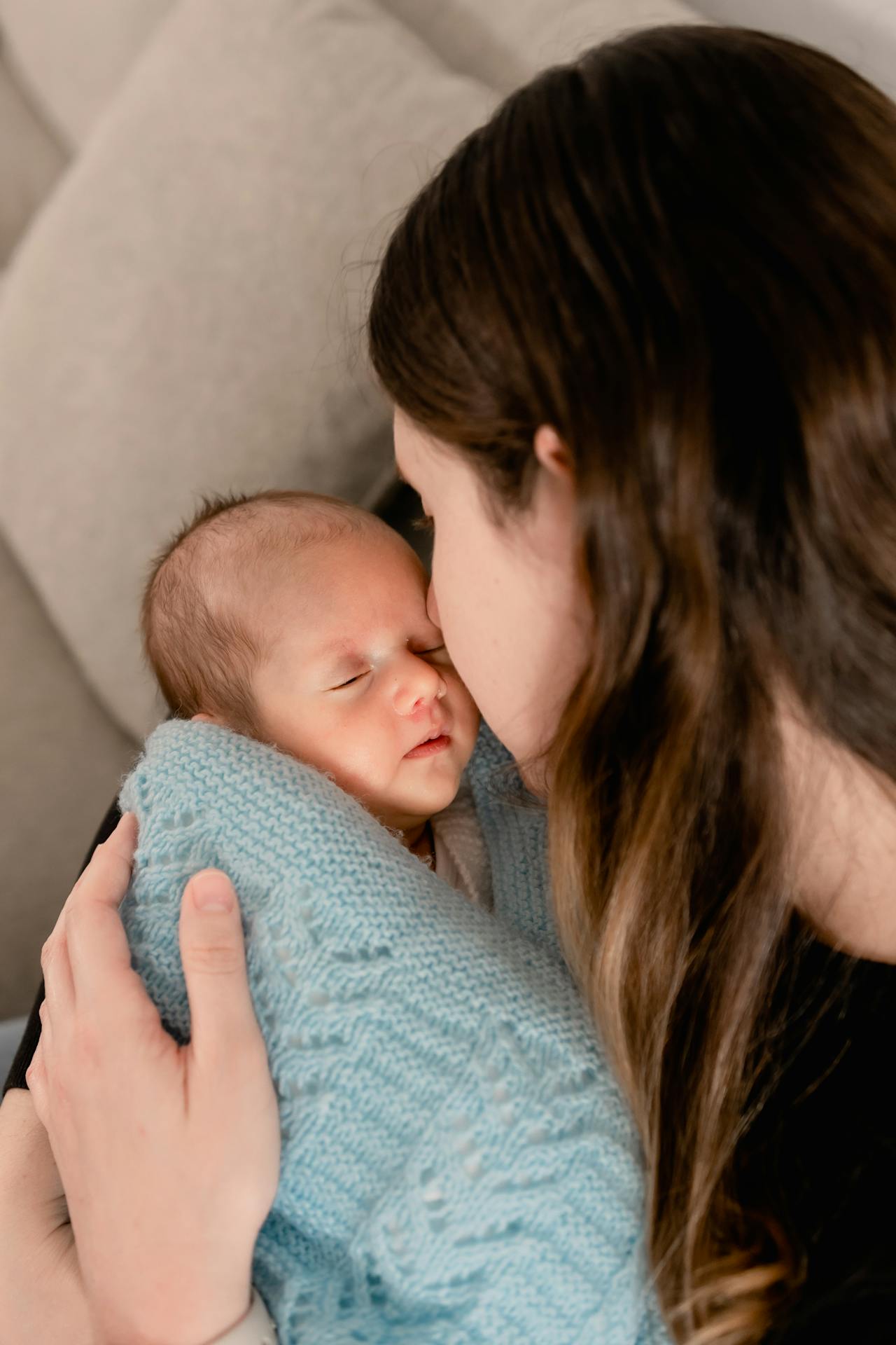 A woman holding her newborn baby | Source: Pexels