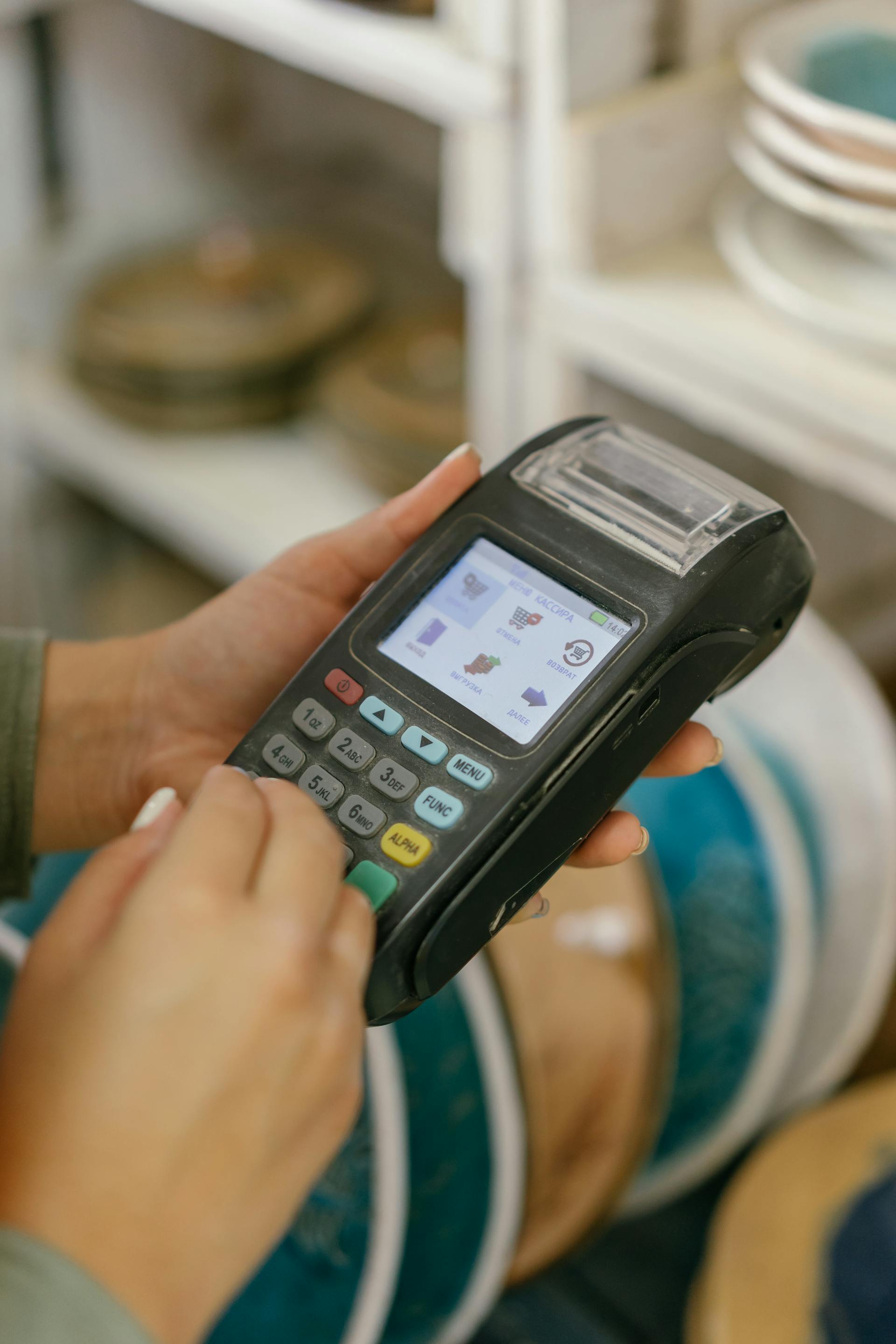 A person holding a POS machine | Source: Pexels