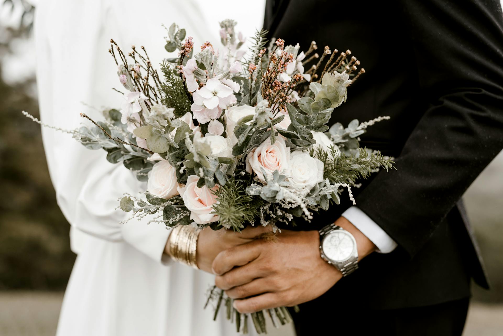 A couple holding a flower bouquet on their wedding | Source: Pexels