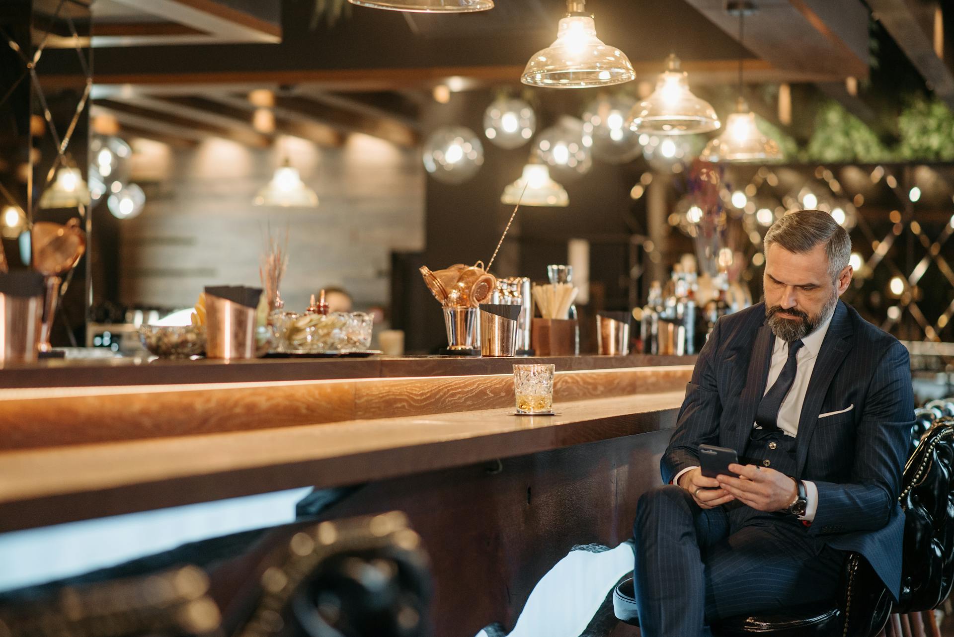 A rich man sitting at a bar at a country club | Source: Pexels