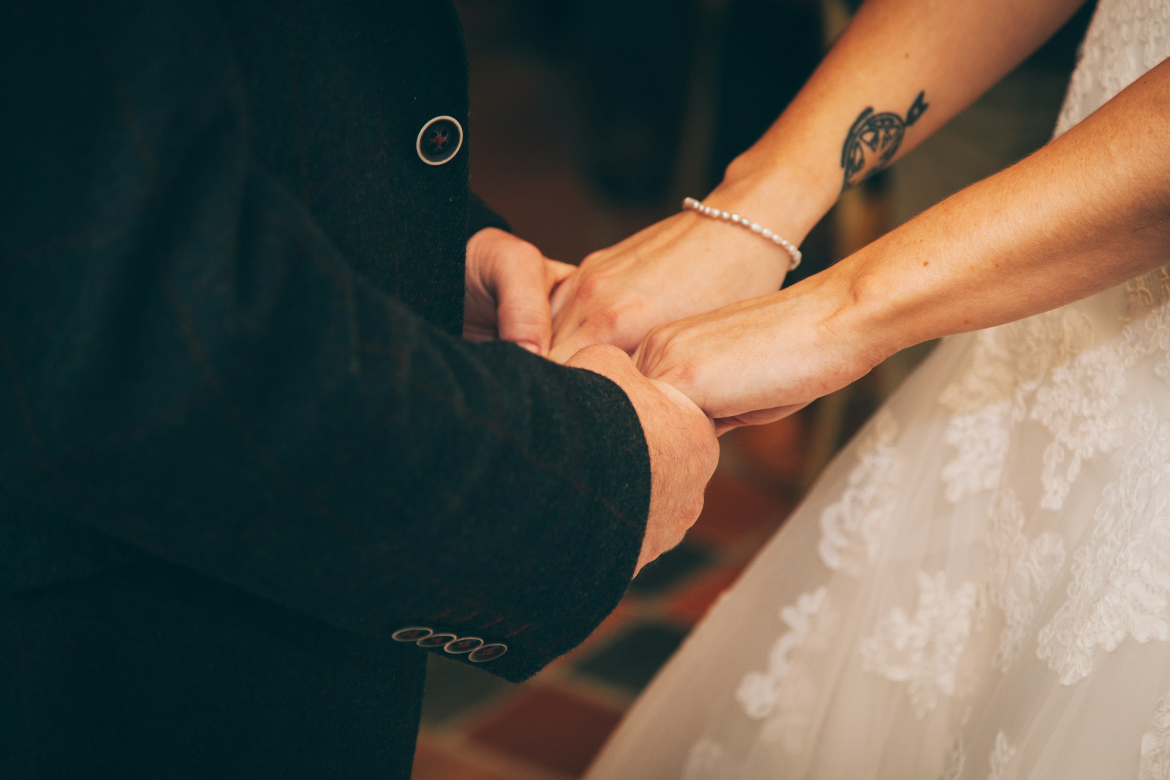 Bride and groom holding hands | Source: Unsplash