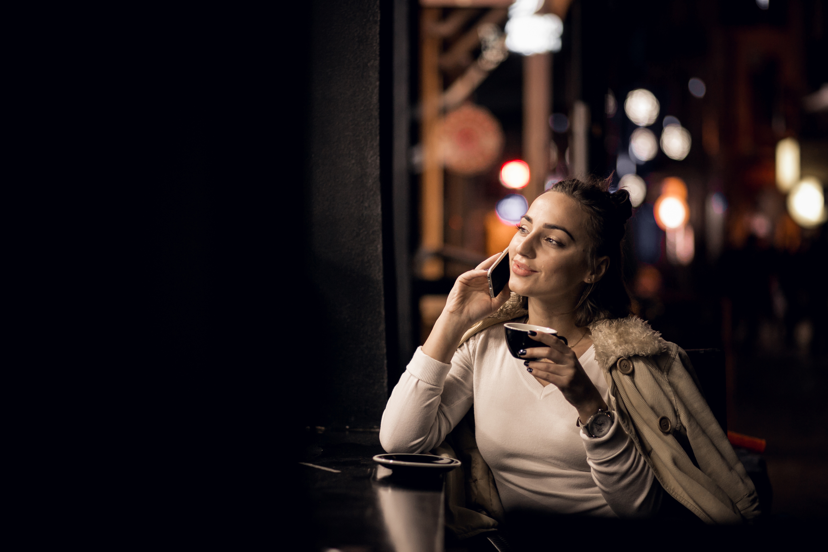 A woman smiling while on a call | Source: Freepik