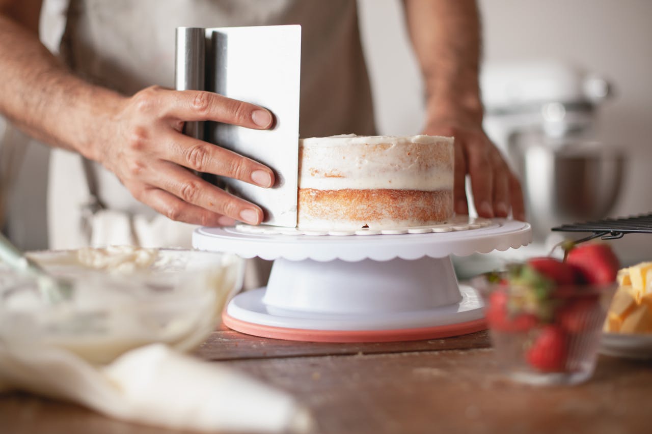 Cropped shot of a man baking a cake | Source: Pexels