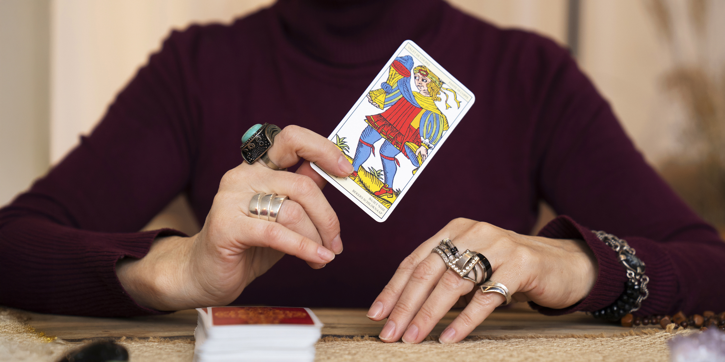 A fortune teller holding a tarot card | Souce: Freepik