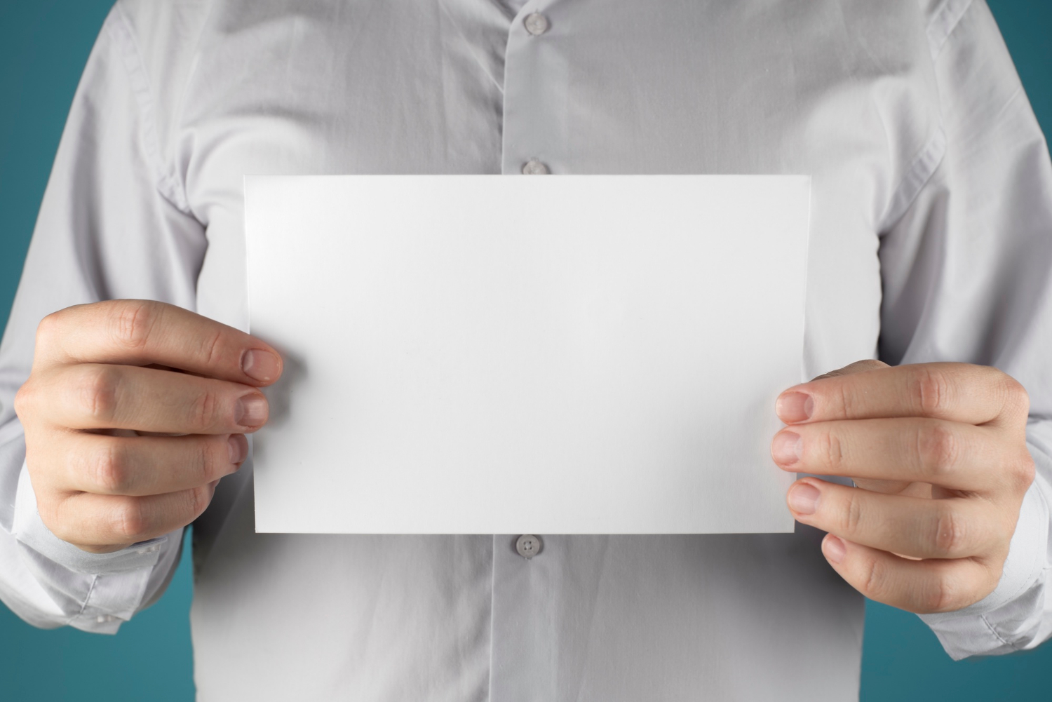 A man holding a sheet of paper | Source: Freepik
