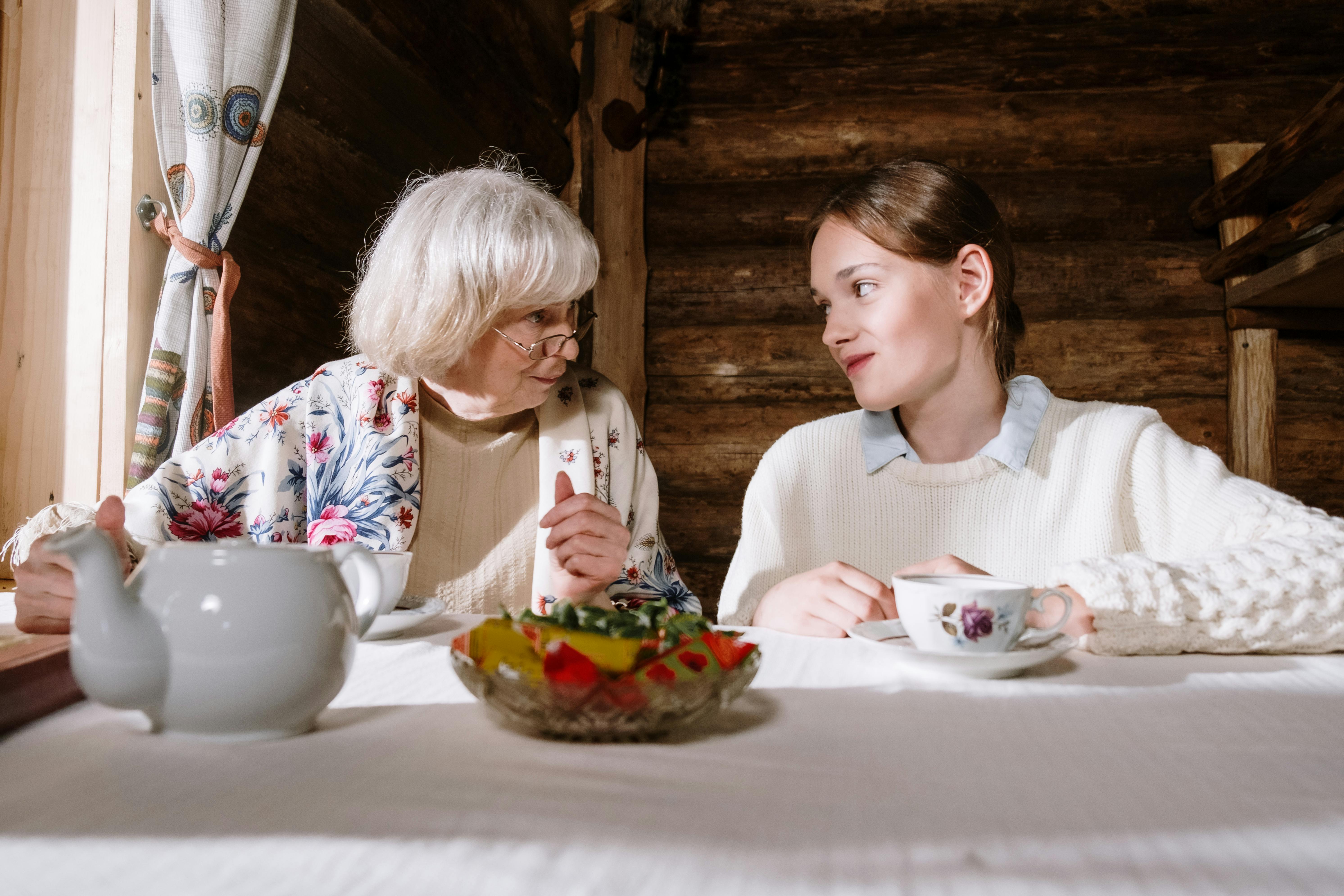 A grandmother and a teenager having tea together | Source: Pexels