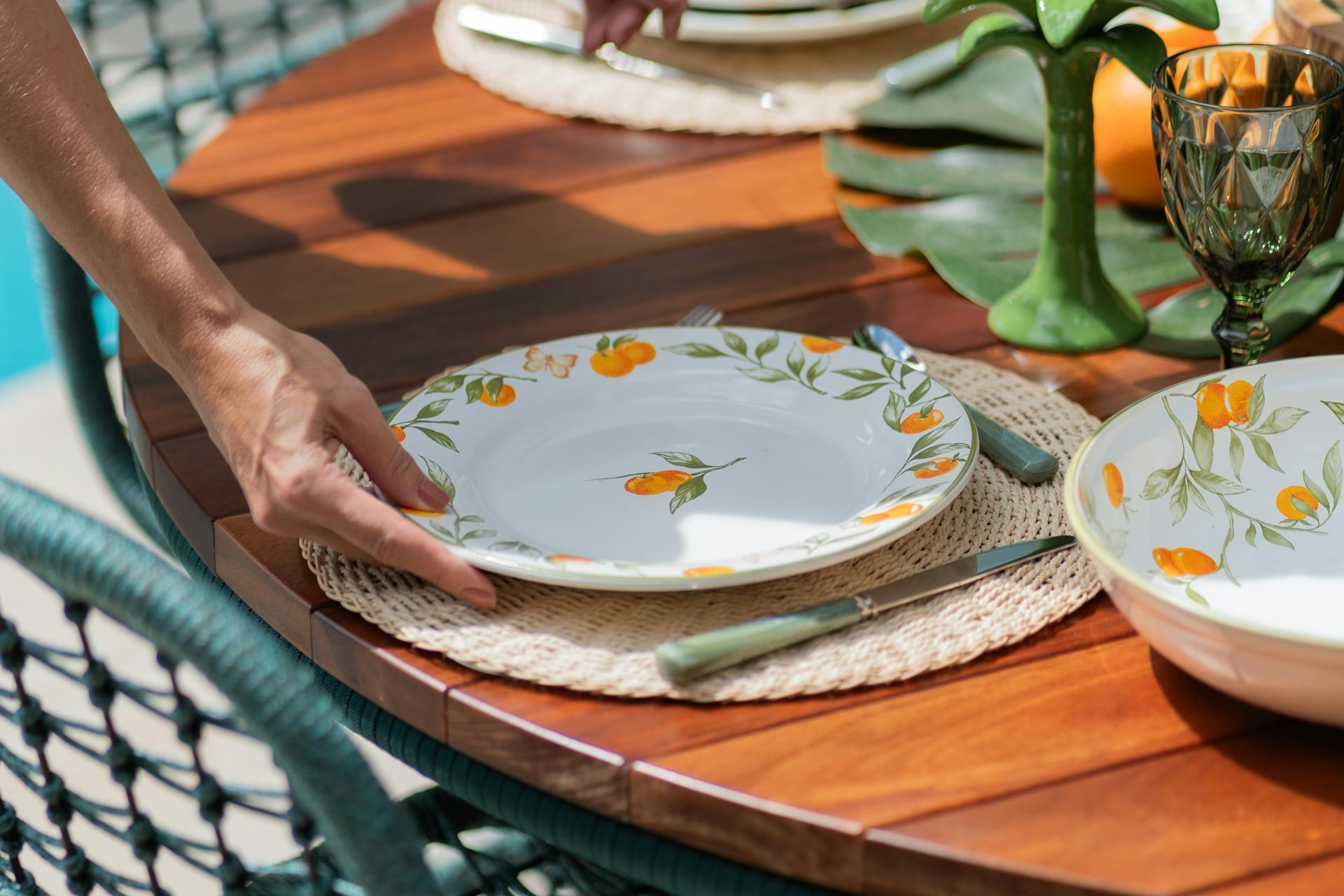 A woman putting a plate on a table | Source: Pexels