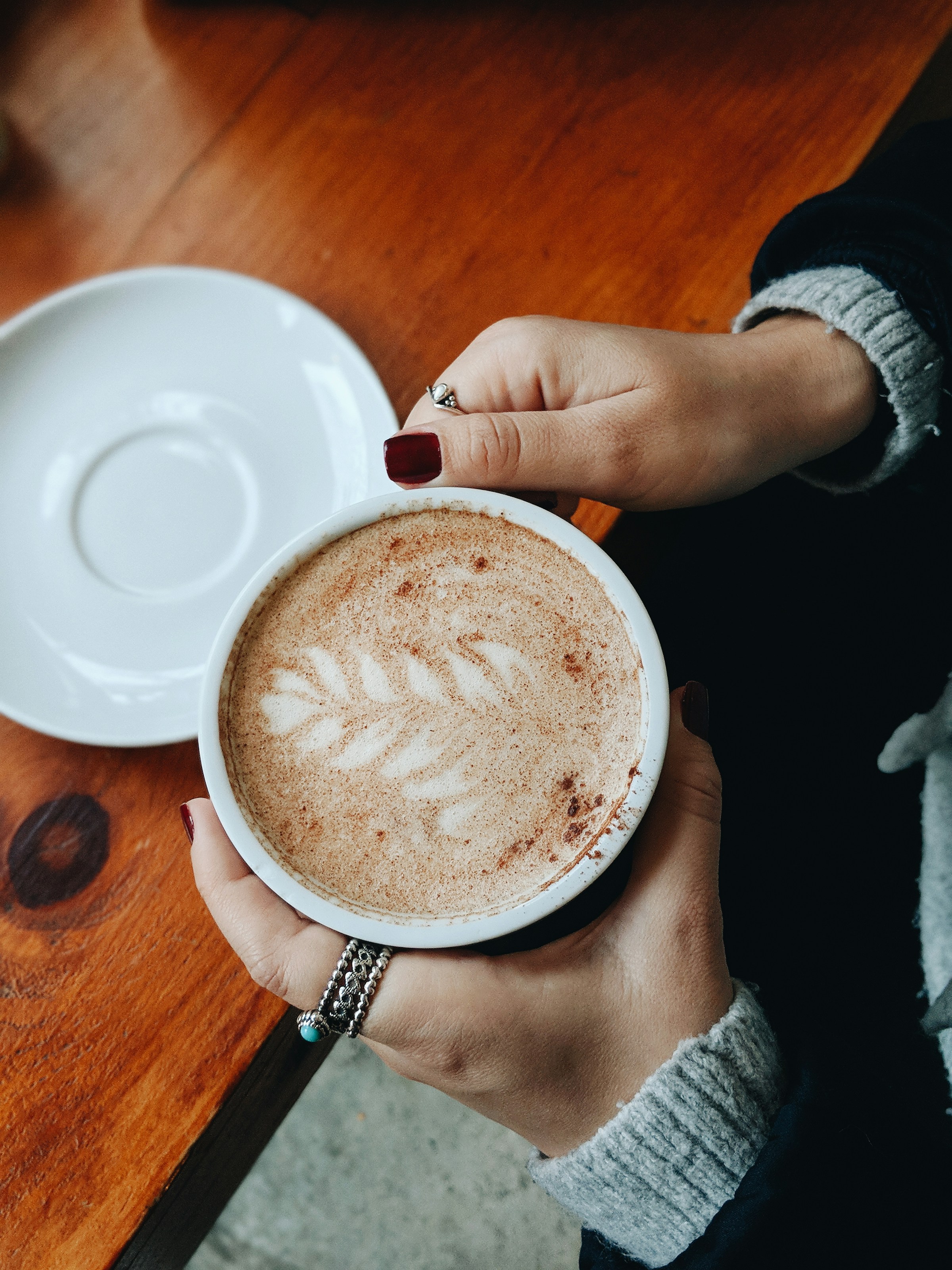 A woman holding a cup of coffee | Source: Pexels