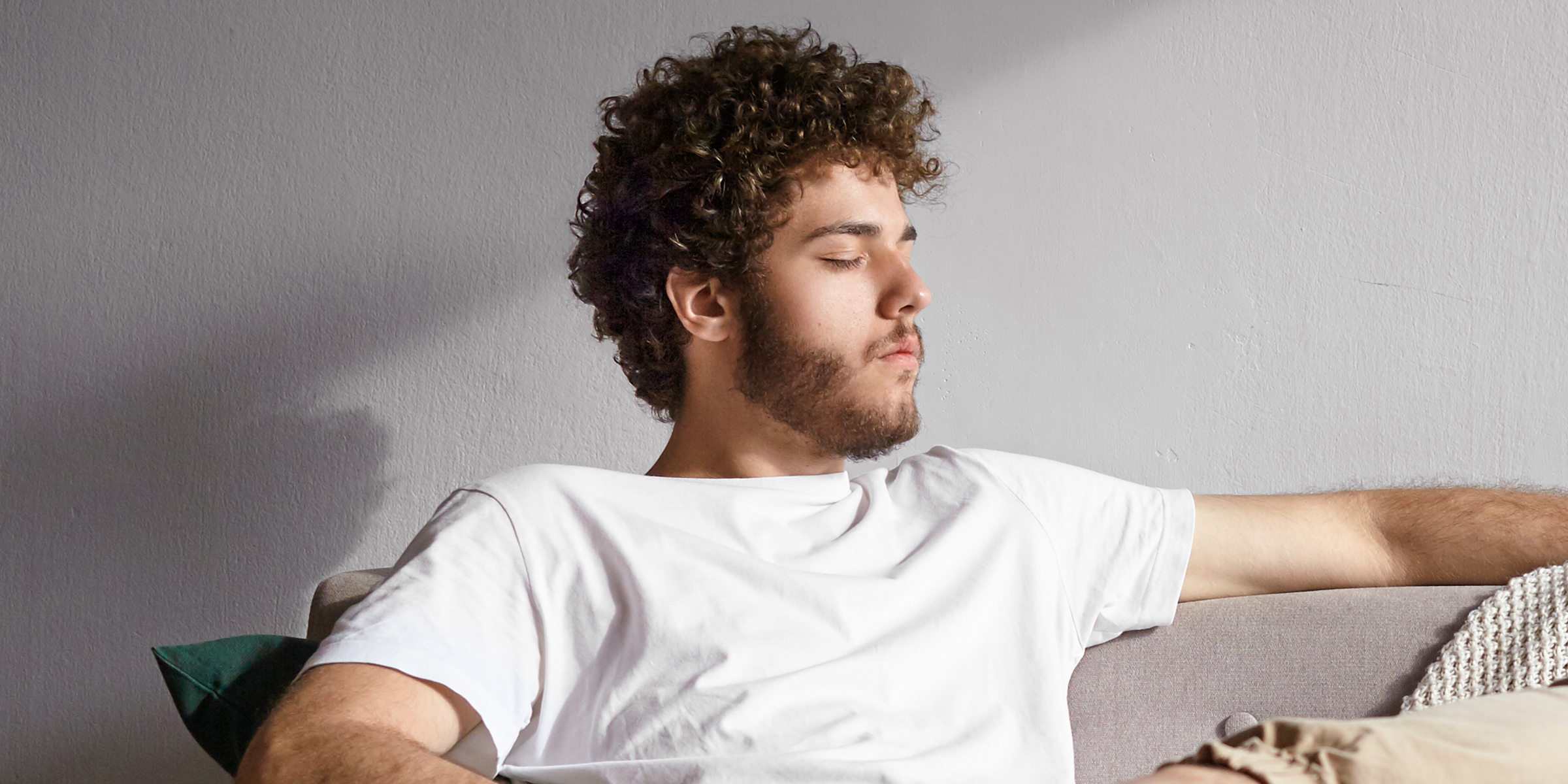 A man relaxing on a sofa | Source: Shutterstock