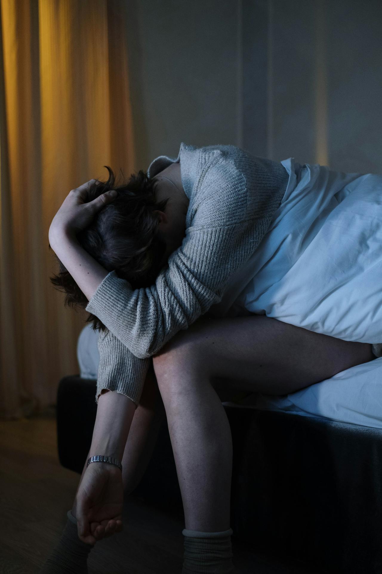 A depressed woman sitting on her bed | Source: Pexels