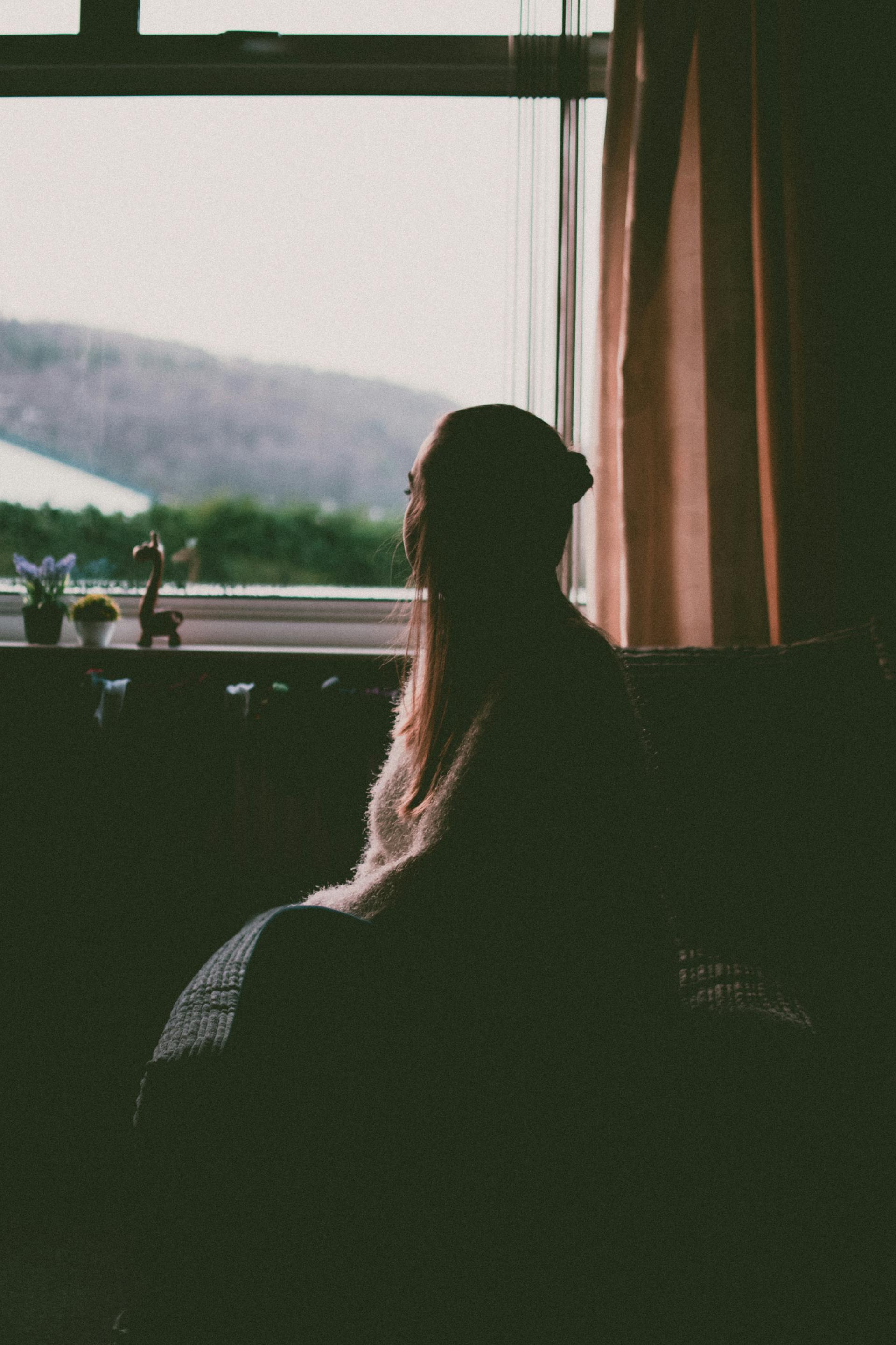 A woman sitting by the window | Source: Pexels