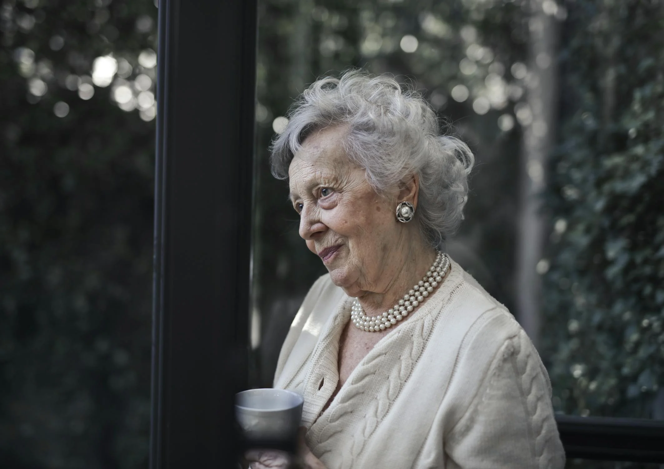 A woman with a coffee cup on her patio | Source: Pexels