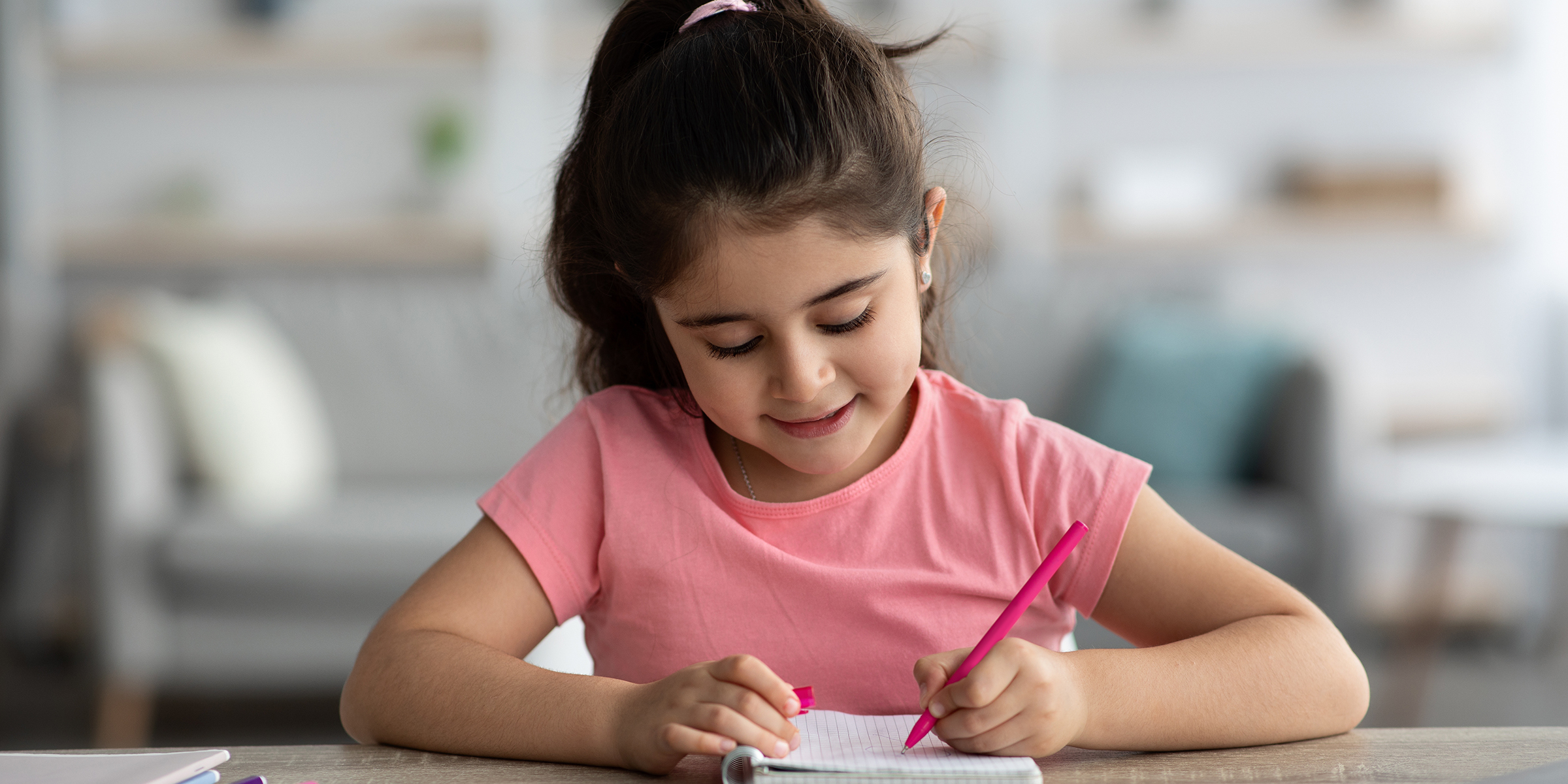 A girl writing on a paper | Source: Shutterstock