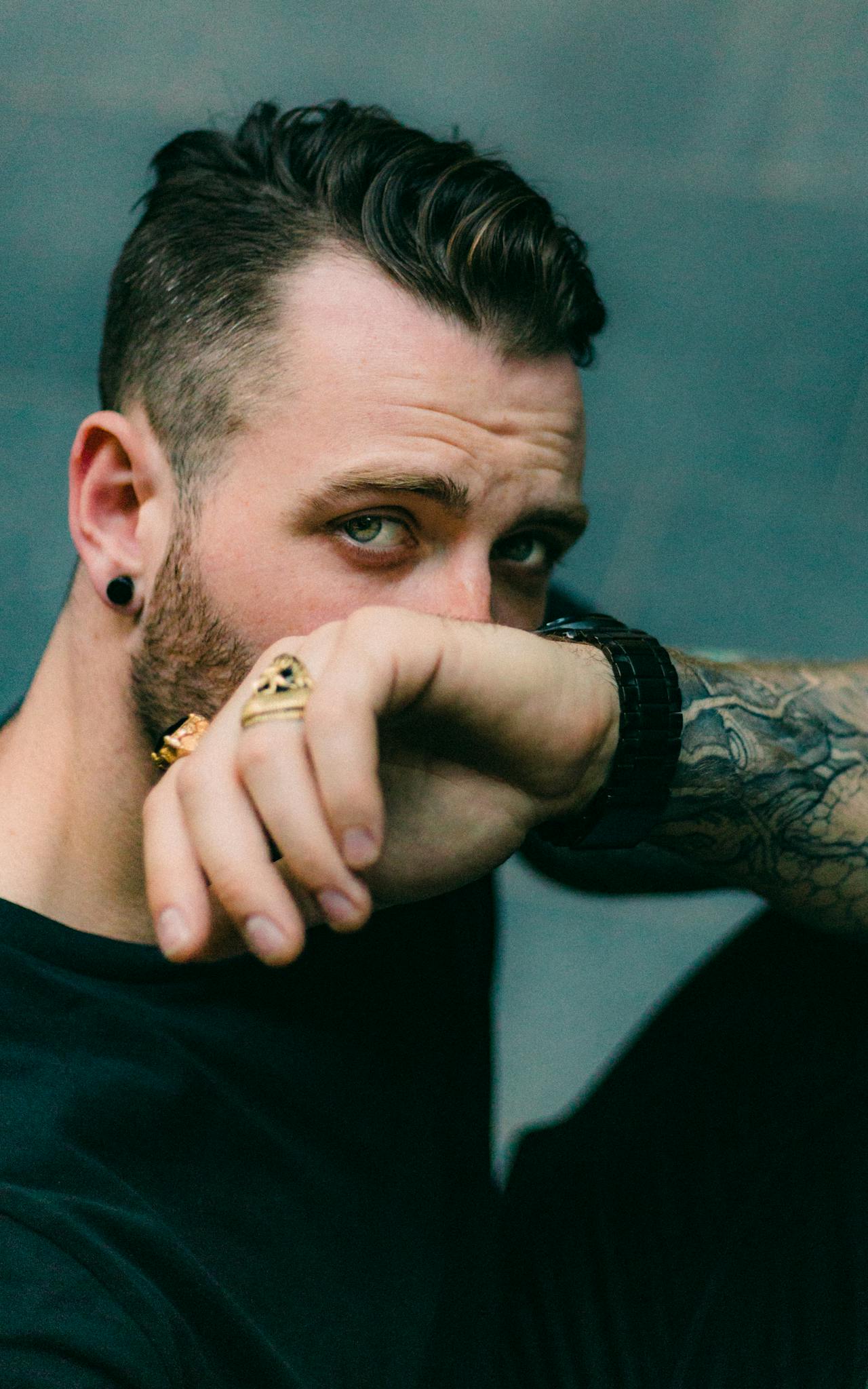 A man partially covering his face | Source: Pexels