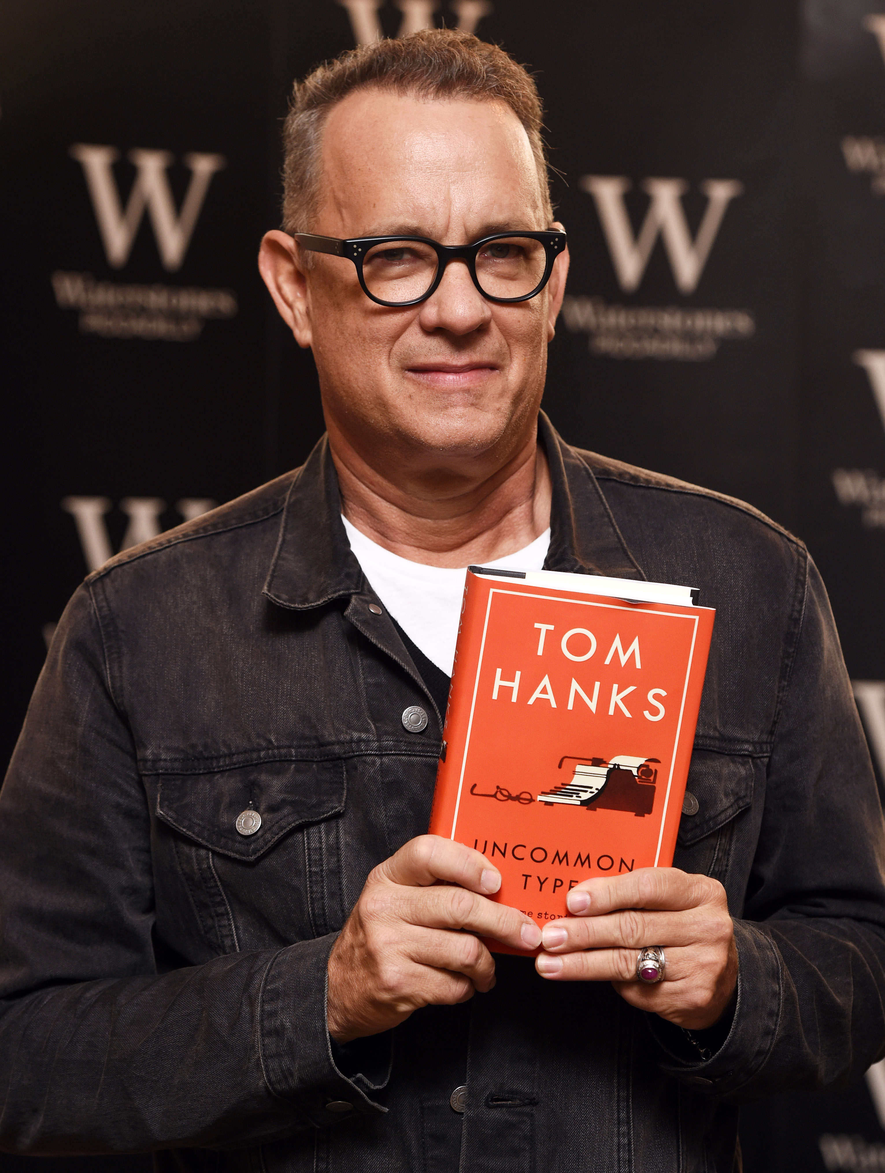 Tom Hanks signs copies of his first book, "Uncommon Type: Some Stories," a collection of 17 short stories focusing around the theme of typewriters. | Source: Getty Images