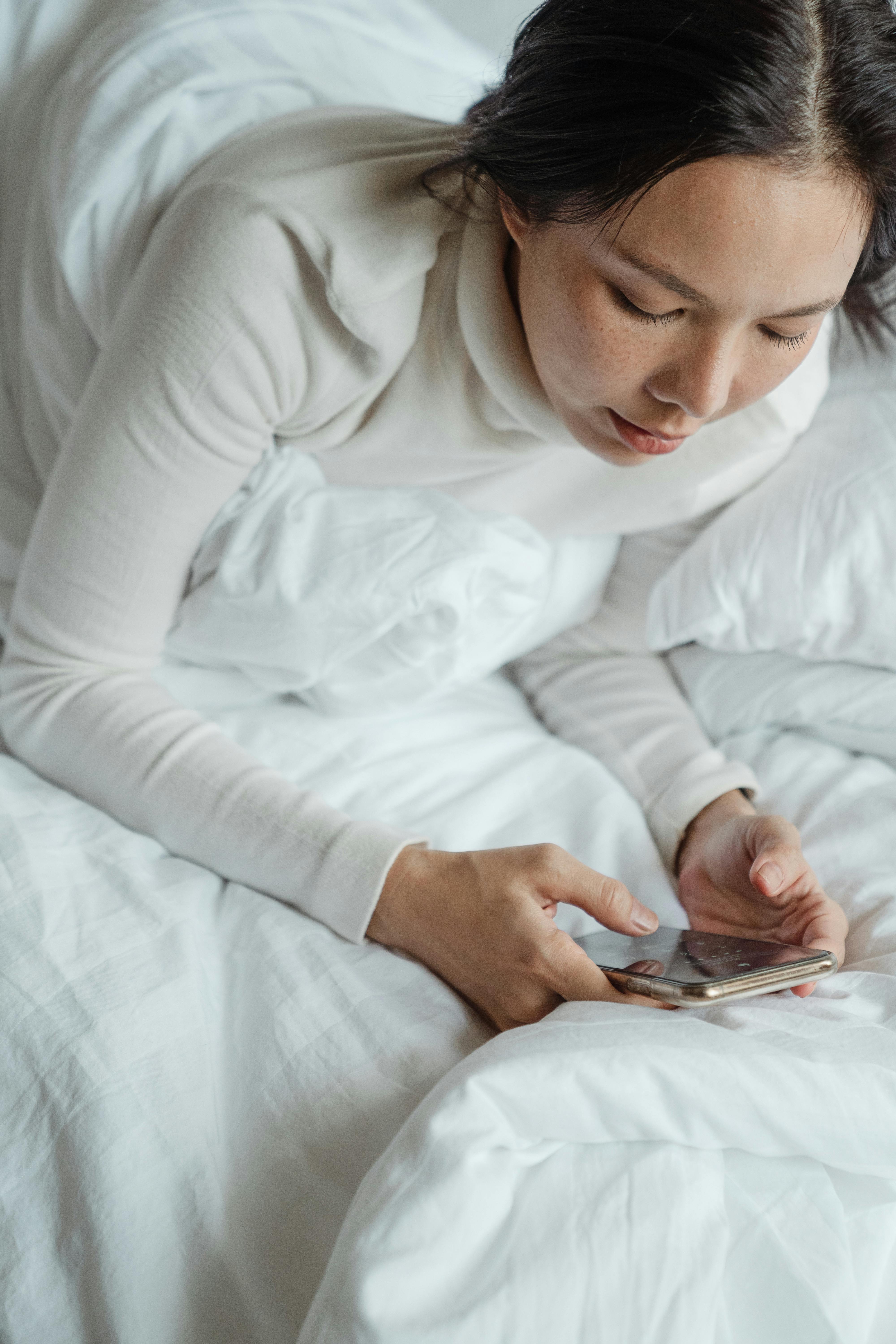 An unhappy woman looking at her phone | Source: Pexels