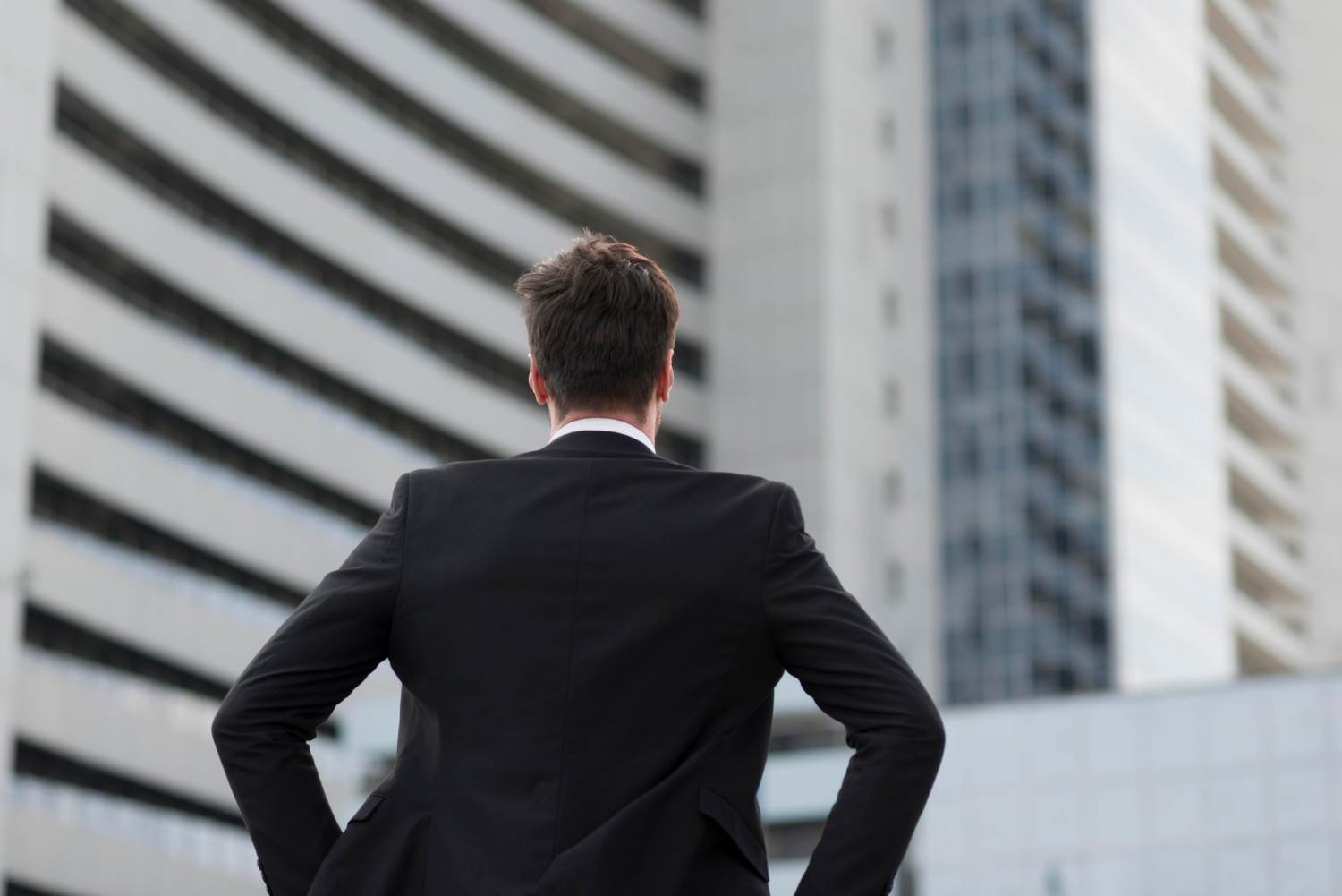 Rear view of a man in black suit | Source: Freepik