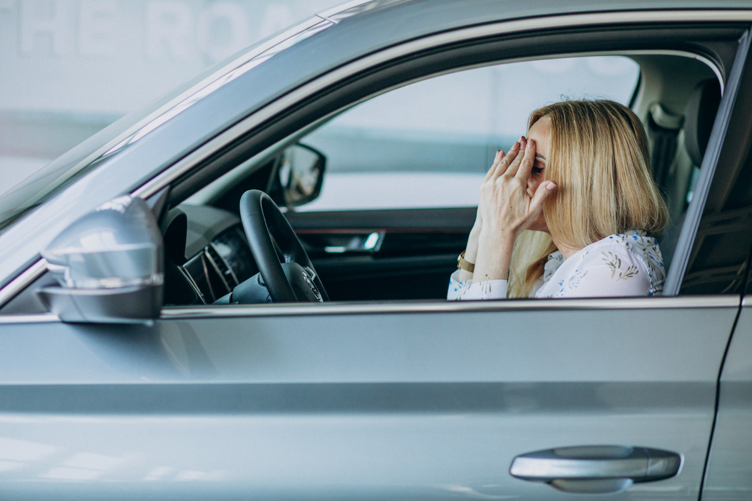 A depressed older woman sitting in the car | Source: Freepik