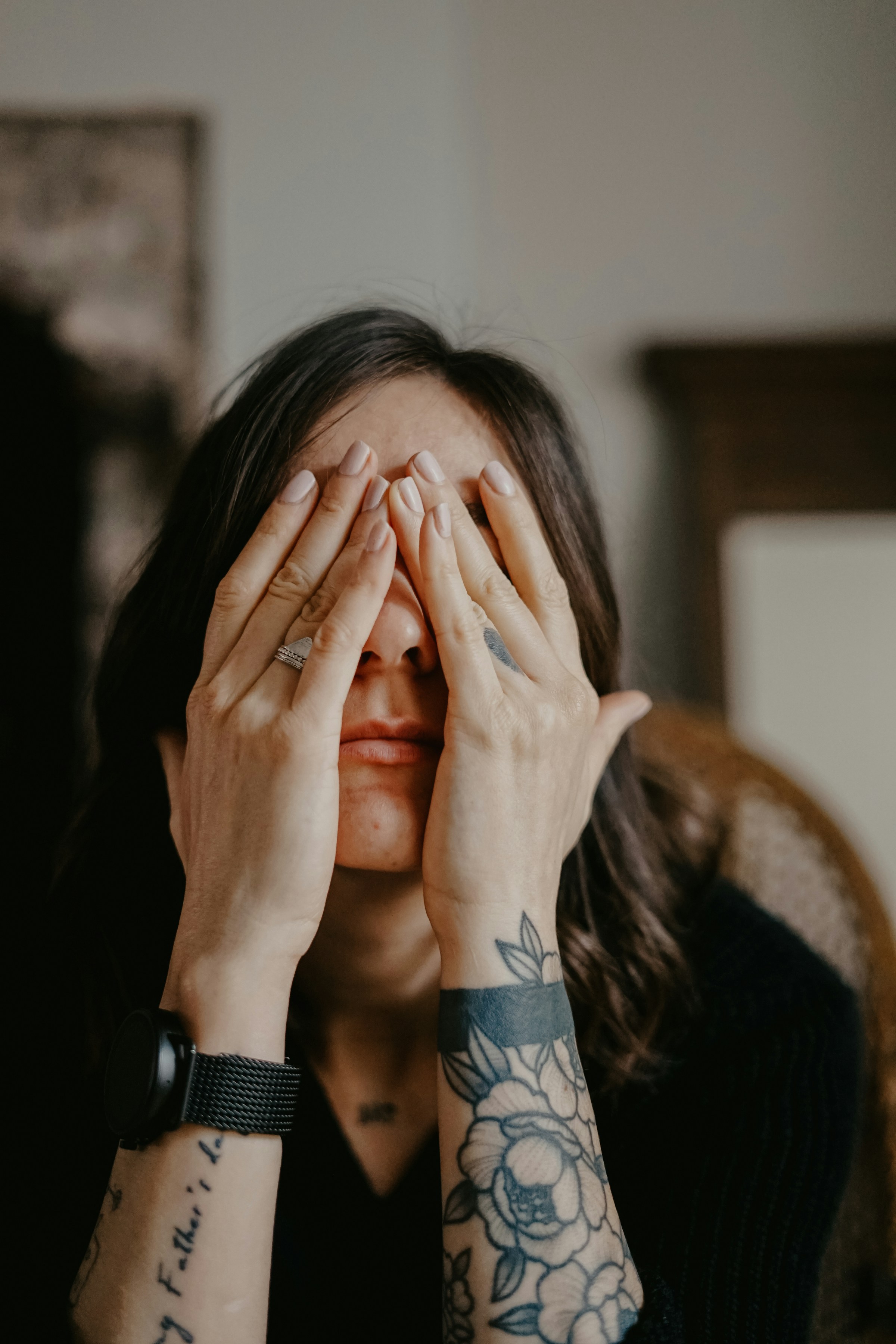 A woman covering her face with her hands | Source: Unsplash