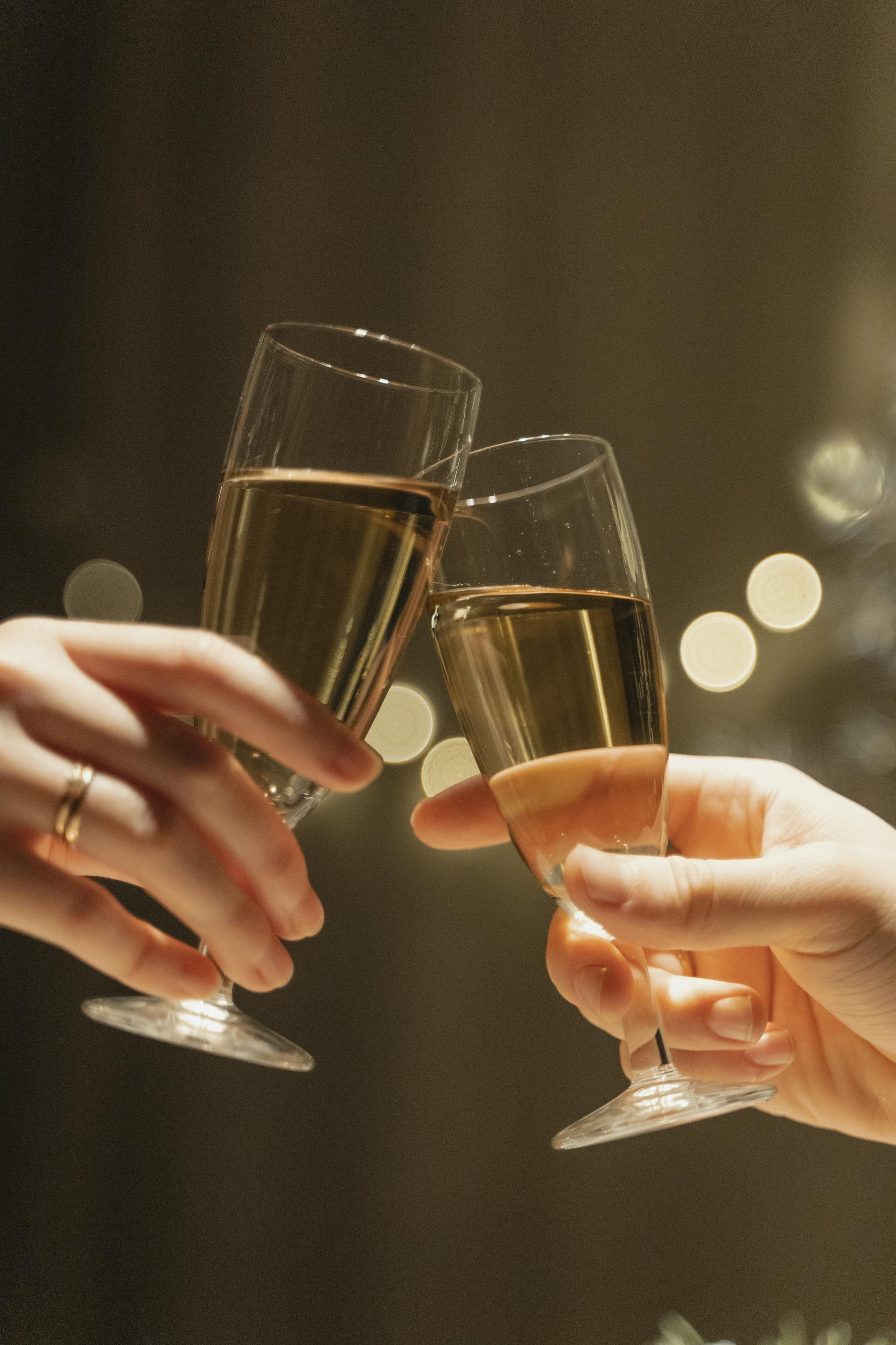 A couple holding glasses in their hands | Source: Pexels