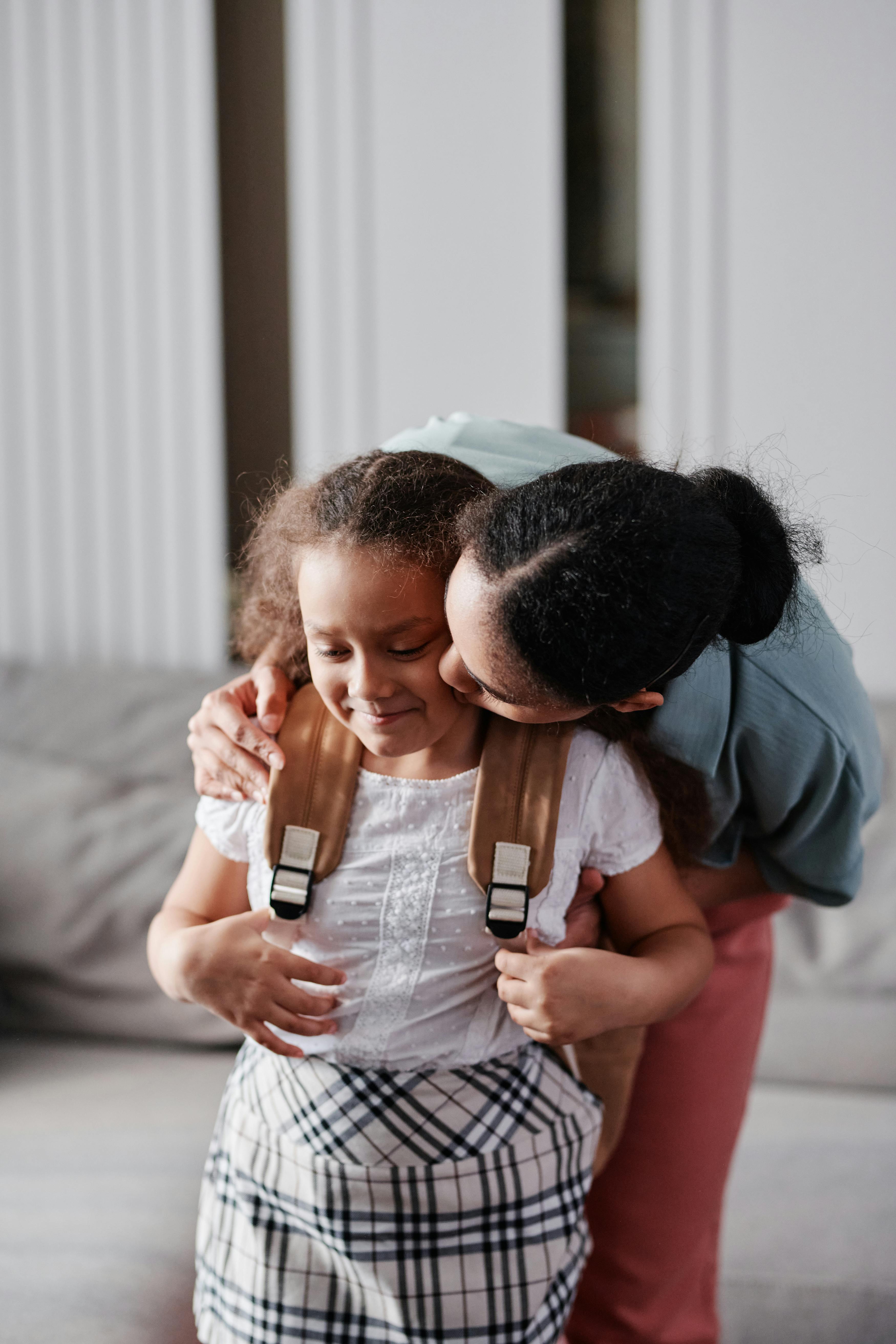 A mother kissing her daughter | Source: Pexels