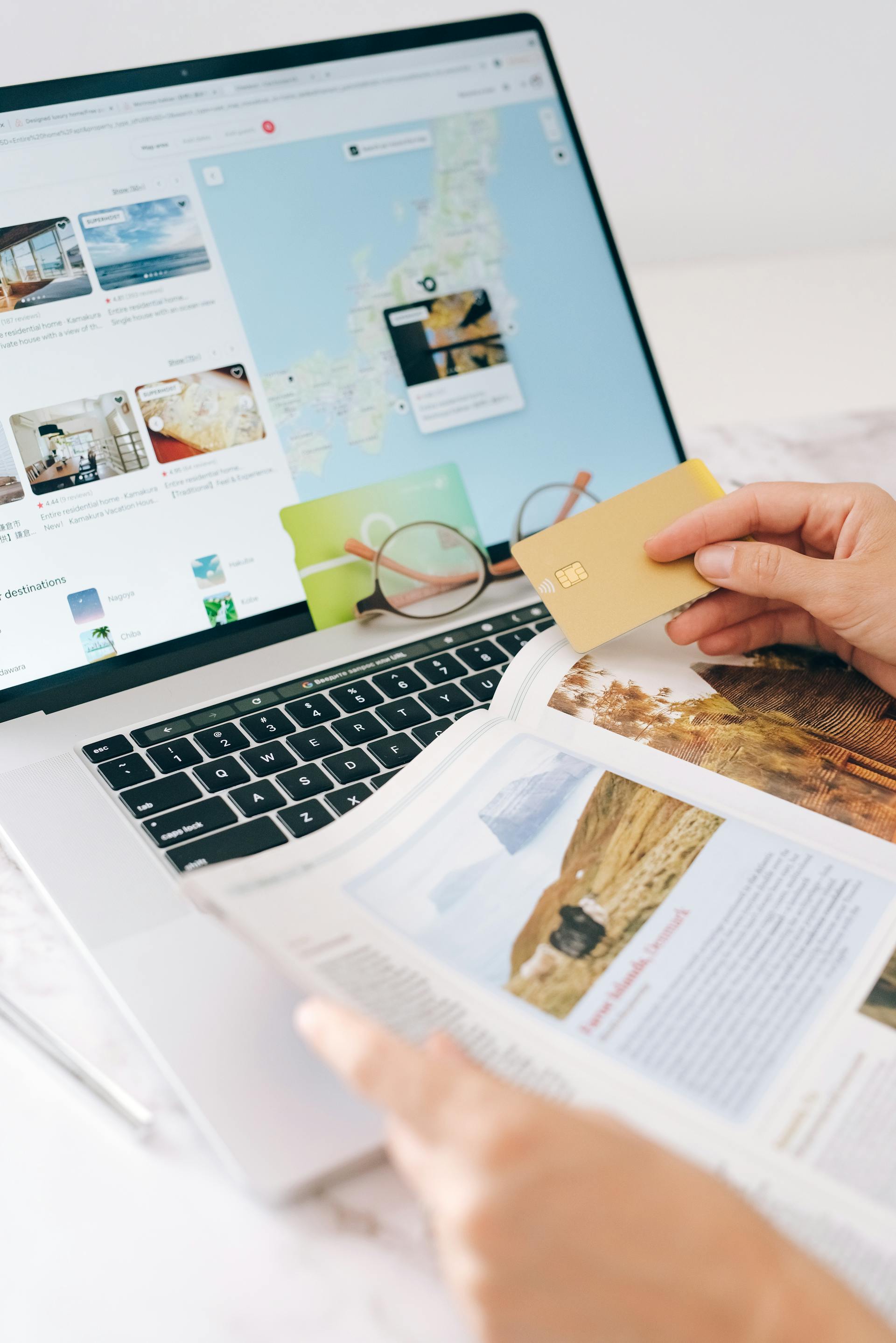 A closeup shot of a person holding a bank card and surfing the internet | Source: Pexels