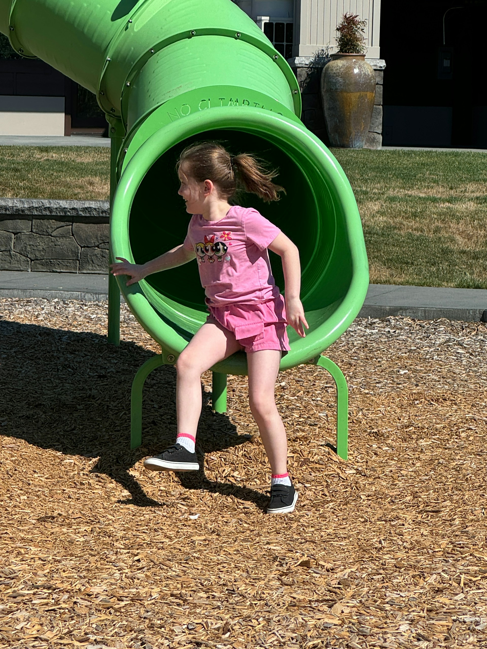 A girl standing near a slide | Source: Unsplash