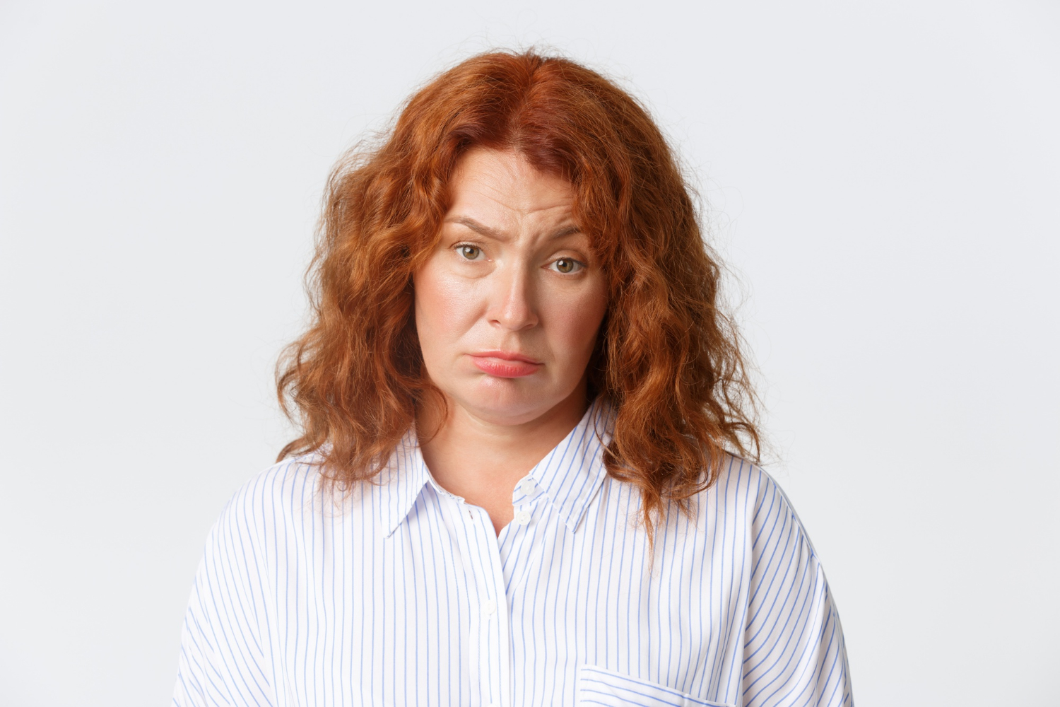 An annoyed woman frowning | Source: Freepik
